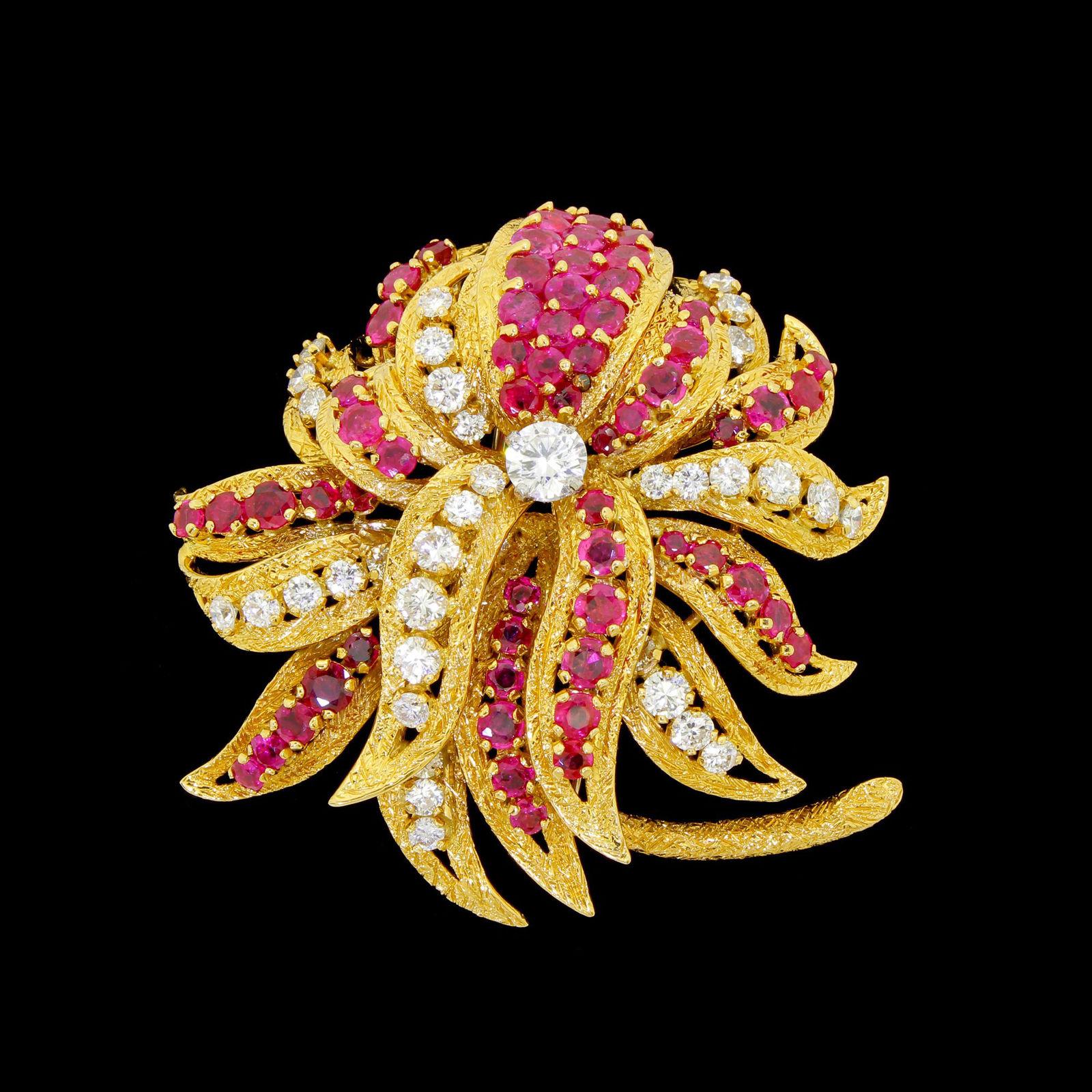 Impressive Kutchinsky Of London floral spray brooch that is made out of thick 18 Karat gold and has an abundance of high quality Diamond and Ruby gemstones.
This magnificent piece has a 3D layered construction, each petal has been individally cast