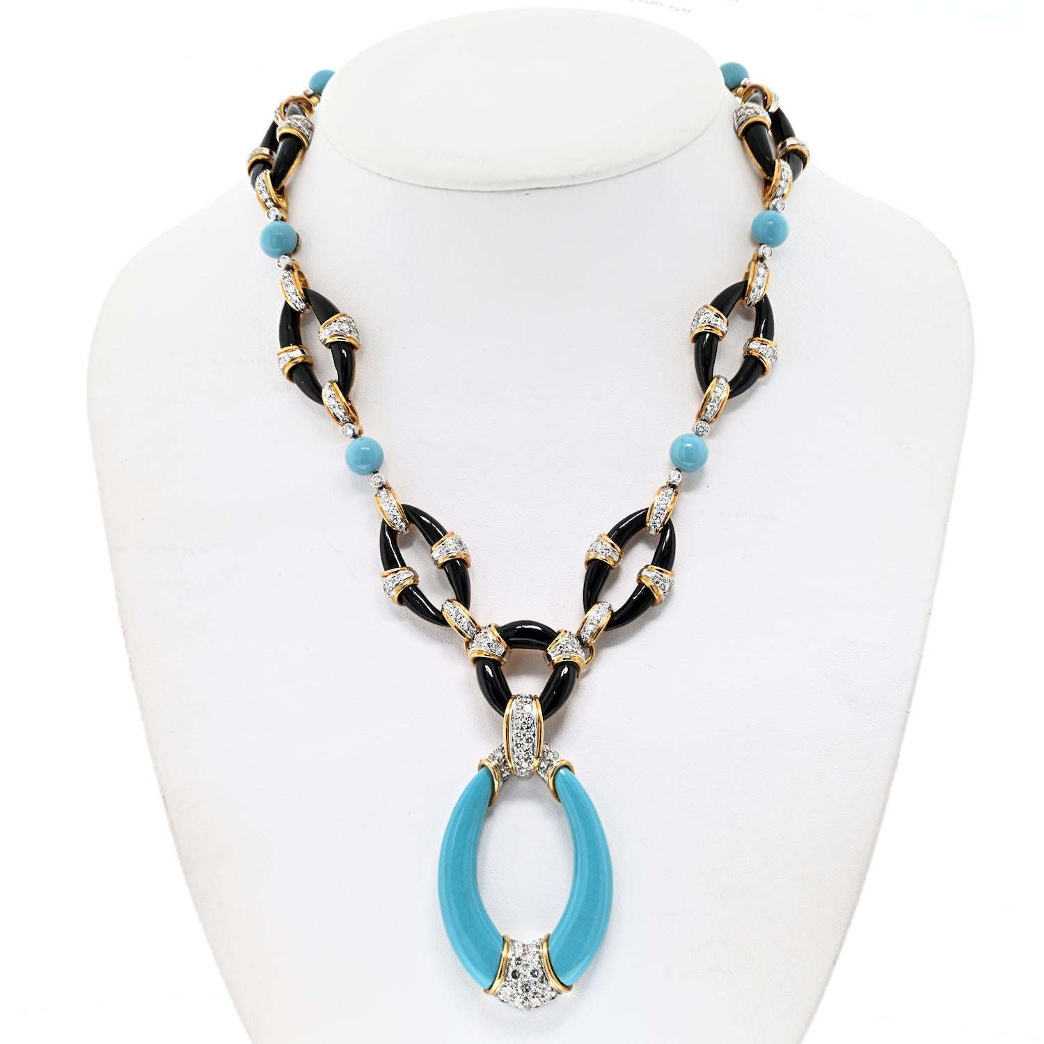 Elevate your style with the Kutchinsky Black Onyx, Reconstituted Turquoise, and Diamond Pendant-Necklace, a stunning piece that seamlessly combines bold design with luxurious gemstones.

The necklace has a length of 17.75 inches, providing a