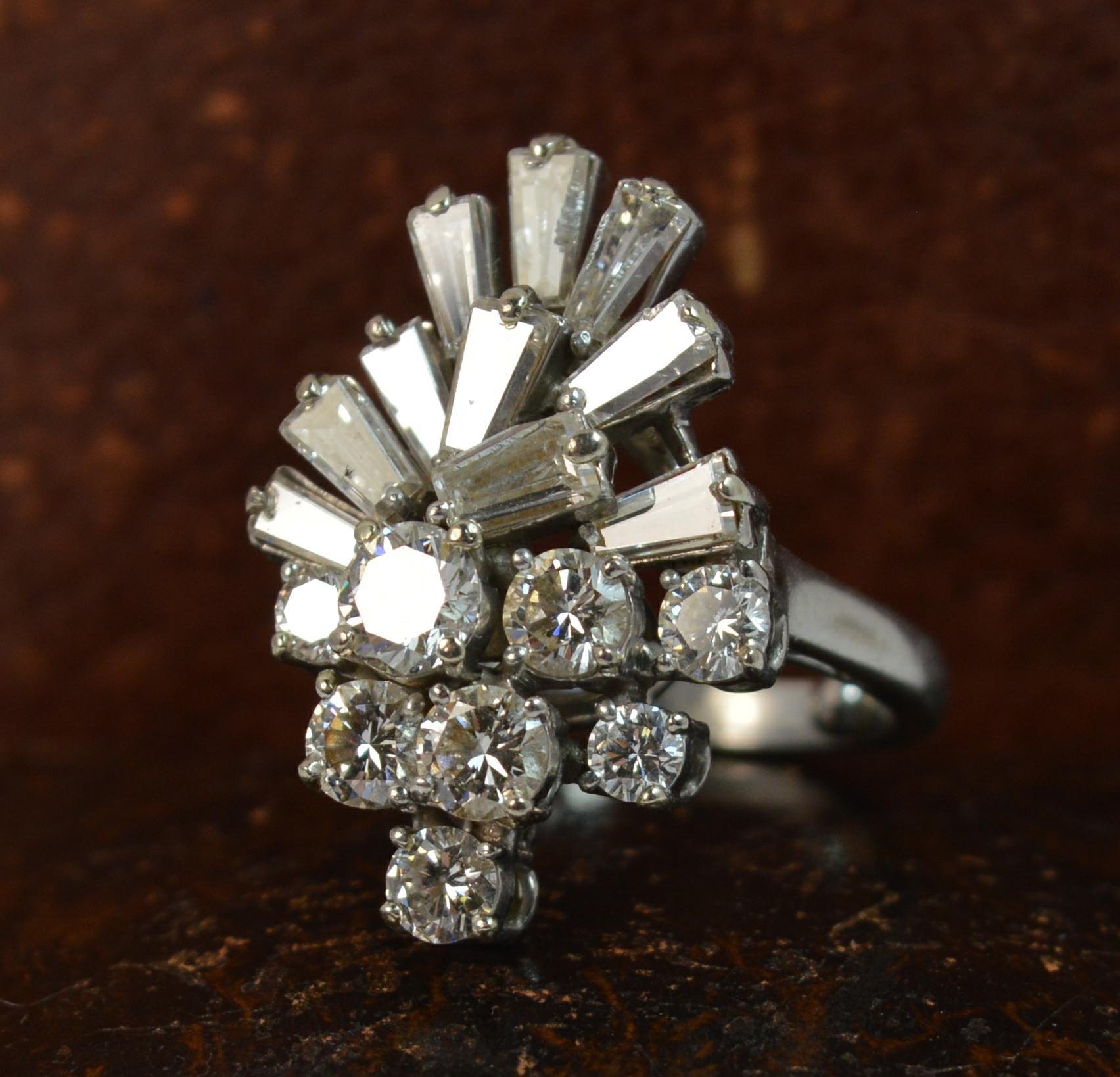 A Platinum and Diamond set ladies cluster cocktail ring. c1975.
SIZE ; L UK, 5 3/4 US, with balls which can be removed, can be sized
Designed by the famous Kutchinsky, renowned for large impression bold pieces of jewellery.
Set with 8 round