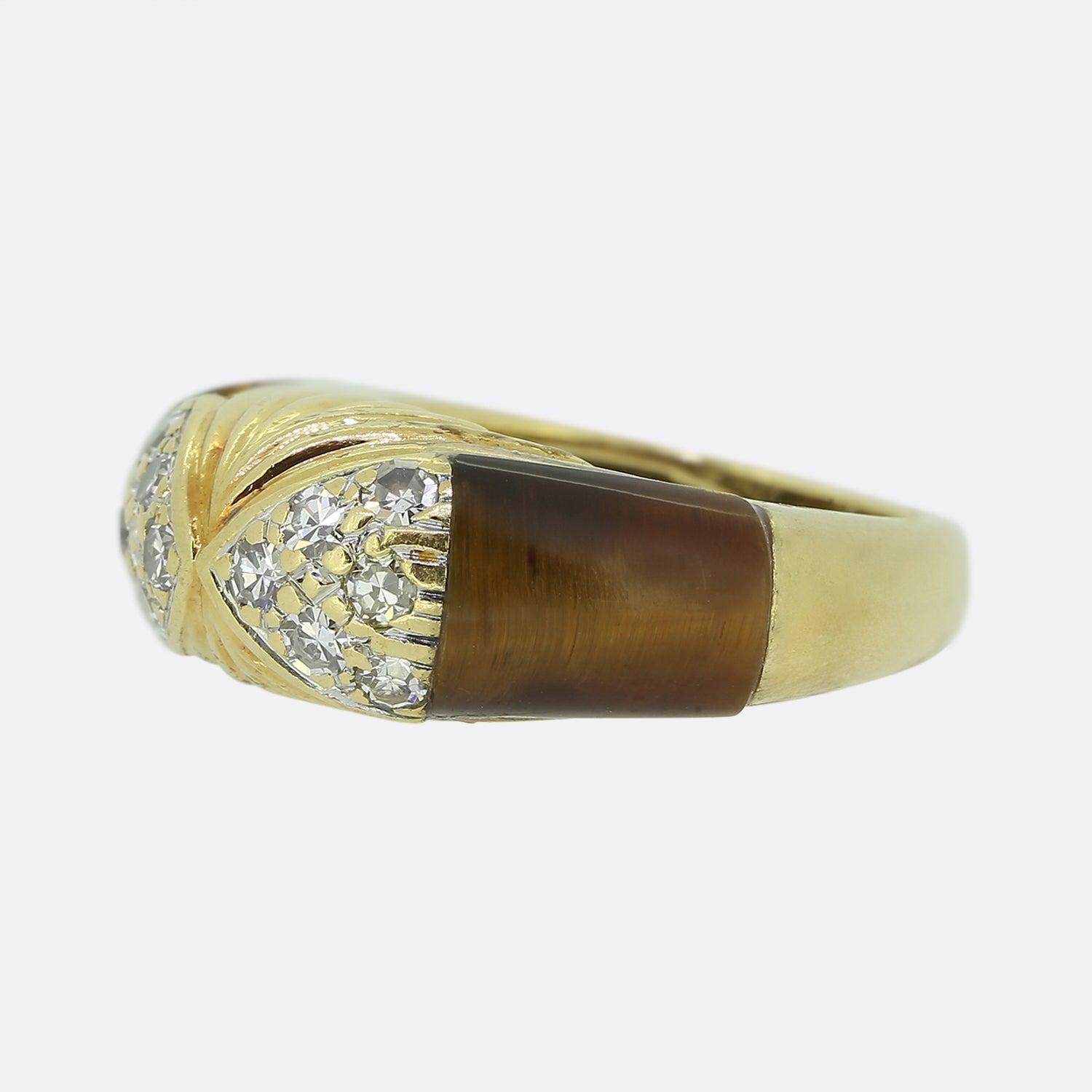 Here we have a beautifully crafted tiger's eye and diamond ring from the notorious London jewellery designer, Kutchinsky. A single calibrated tiger's eye is set at either shoulder which graduates towards a centralised pair of single cut diamond