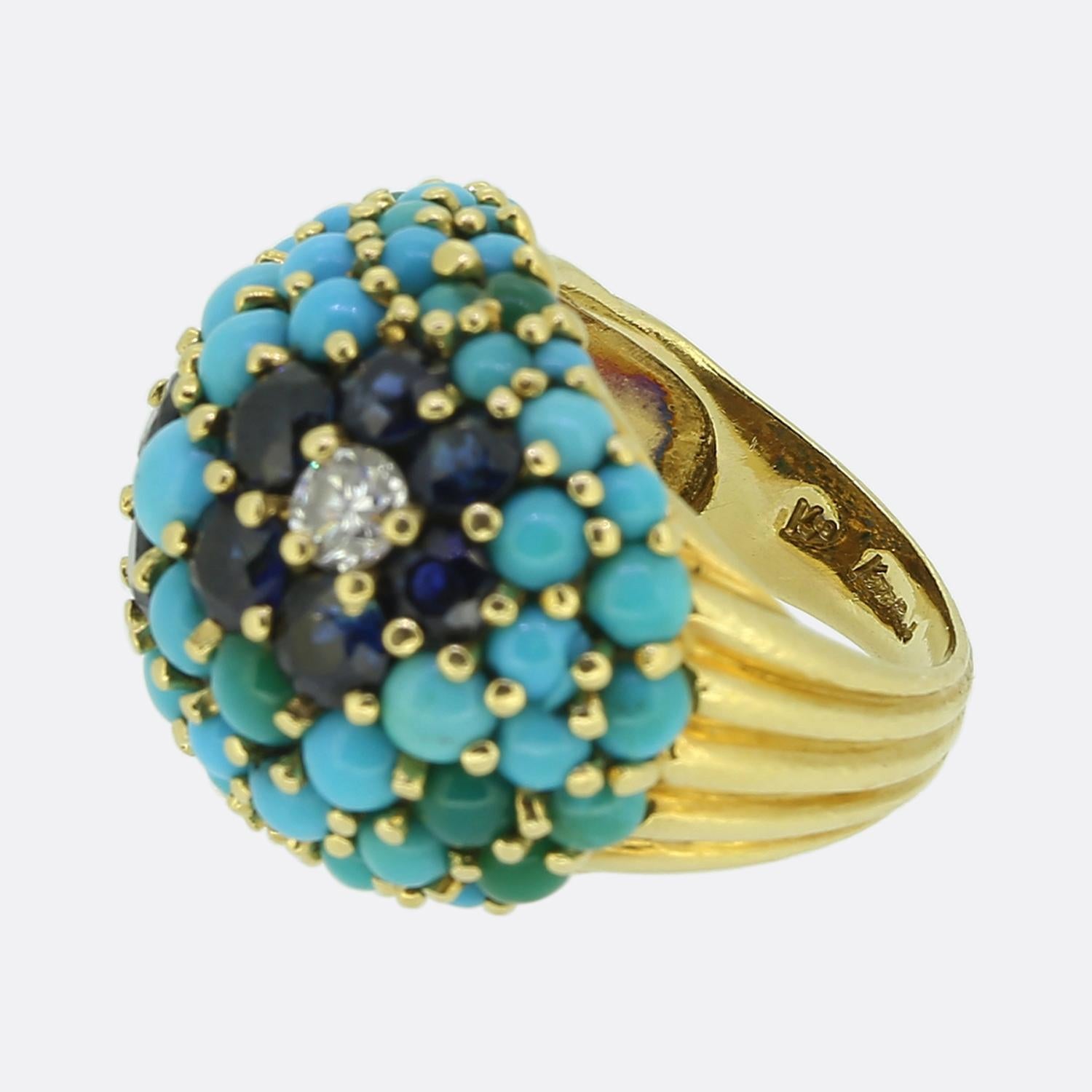 Un anillo maravilloso y divertido del diseñador de joyas de lujo Kutchinsky. El anillo data de los años sesenta y está engastado con turquesa, zafiro y diamantes. Las gemas forman un diseño floral y el anillo está elaborado en oro amarillo de 18
