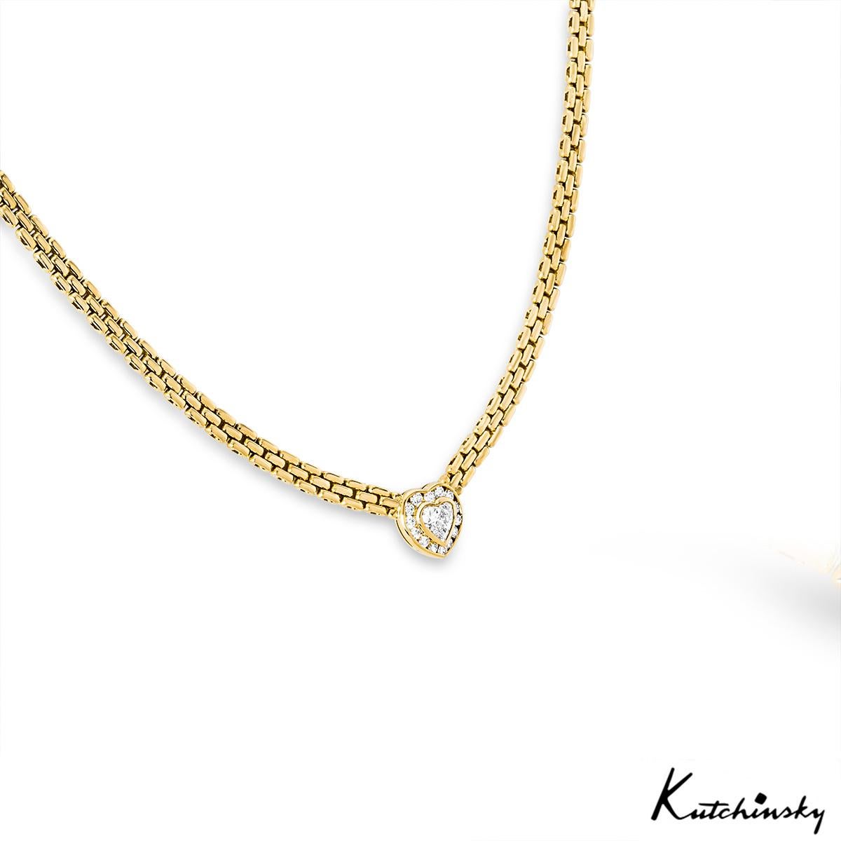 A beautiful 18k yellow gold diamond necklace by Kutchinsky. The necklace is bezel set to the centre with a heart shaped diamond weighing approximately 1.00ct, G-H colour and VS clarity. The centre stone is further complemented with 14 round
