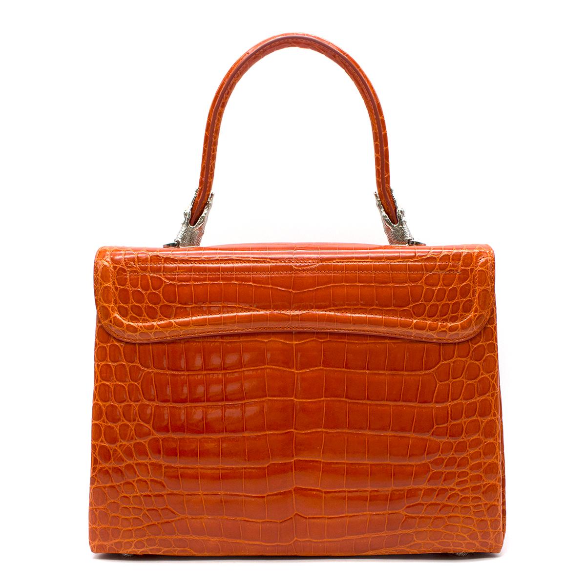Kwanpen Orange Croc Leather 5568 Signature Handbag 

- Orange Crocodile Leather Signature Handbag 
- Characterised by the signature crocodile motif hardware, silvertoned
- Interor features: 1 Large Compartment; 2 Zip Compartments; 2 Interior Slip