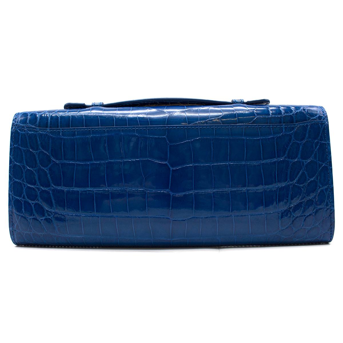 Kwanpen Tanzanite Croc Leather Raffles 1819 Clutch

- Current from The Raffles Collection 
- Structured lines with iconic Raffles hardware, gold toned 
- Carried by top handle or shoulder chain strap.
- Internal features: 1 Large Compartment; 1