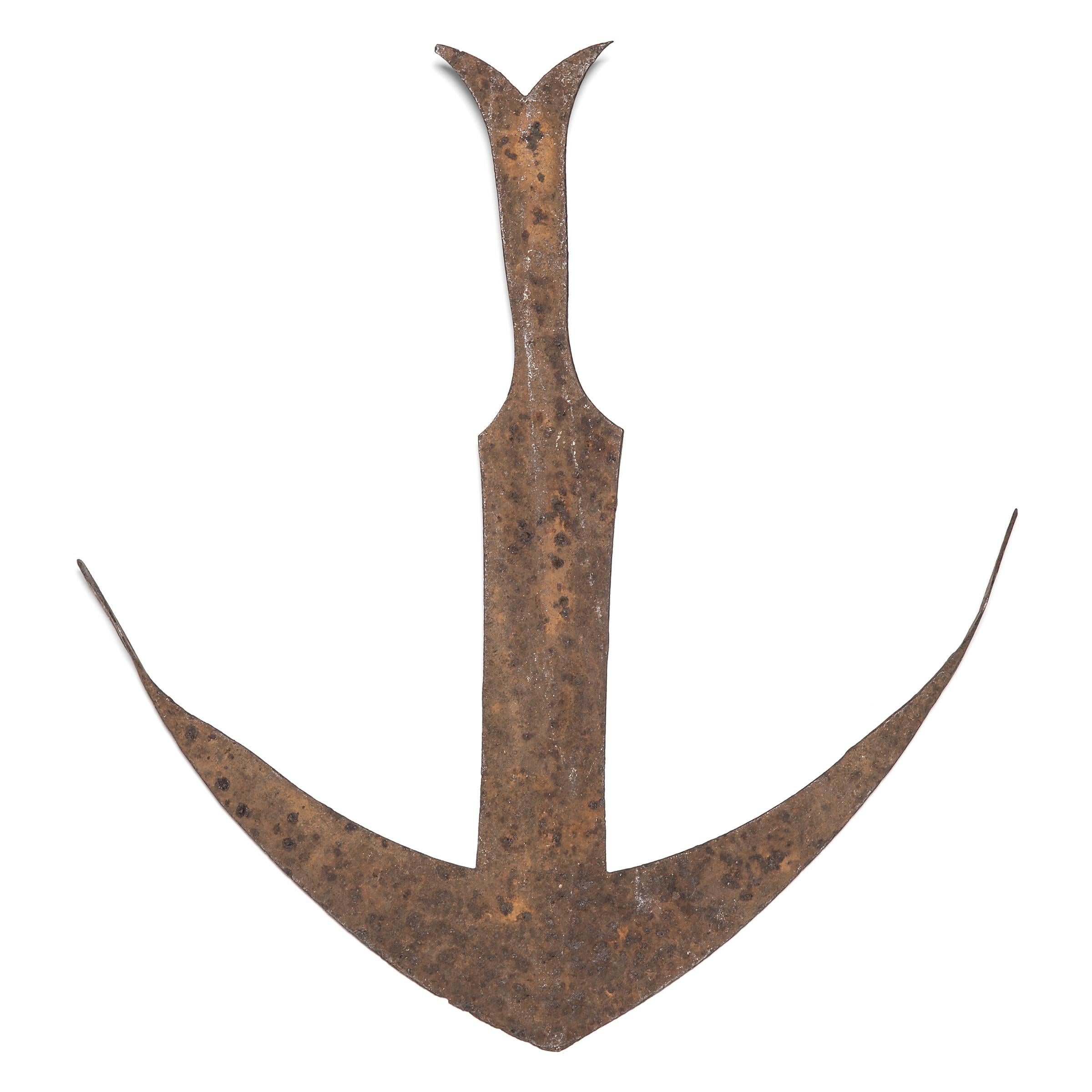 Formed in the shape of an anchor, this graceful iron currency piece was forged by the Kwele people of Gabon and the Democratic Republic of Congo to trade and store wealth. Prized as an object of great value, the currency was often hidden away and