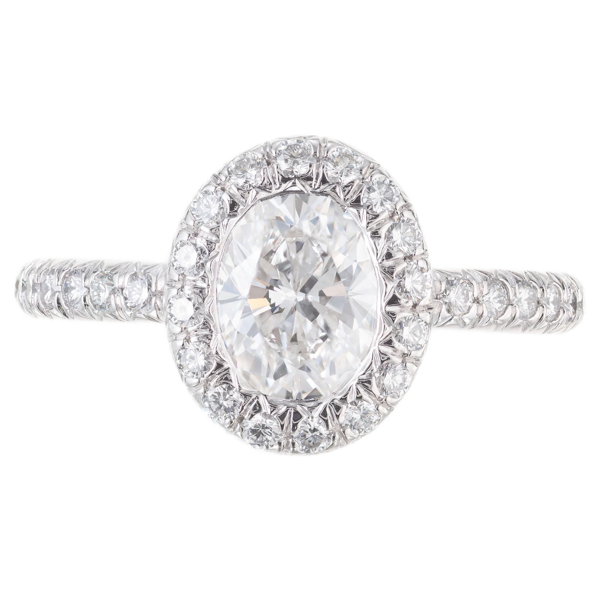  Kwiat oval diamond halo engagement ring. EGL certified 1.10ct oval center stone with a halo of round full cut diamonds in a platinum setting with diamonds along both sides of the shank and crown.  

1 oval diamond approx. total weight 1.10cts, EGL
