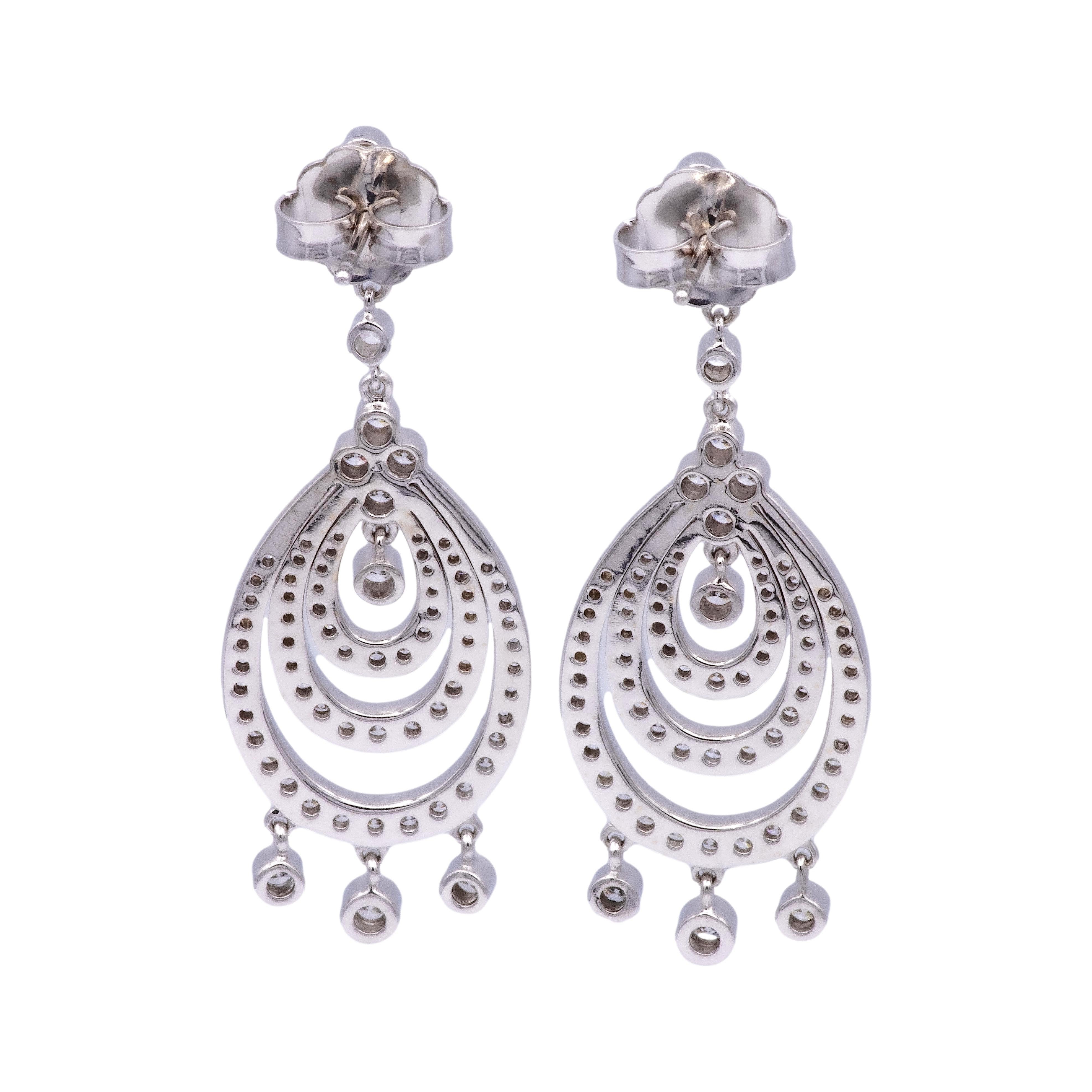 Pair of chandelier drop diamond earrings signed by KWIAT finely crafted in 18 karat white gold featuring channel and bezel set round brilliant cut diamonds weighing 3 carats total weight approximately in F-G color and VVS clarity. The earrings have