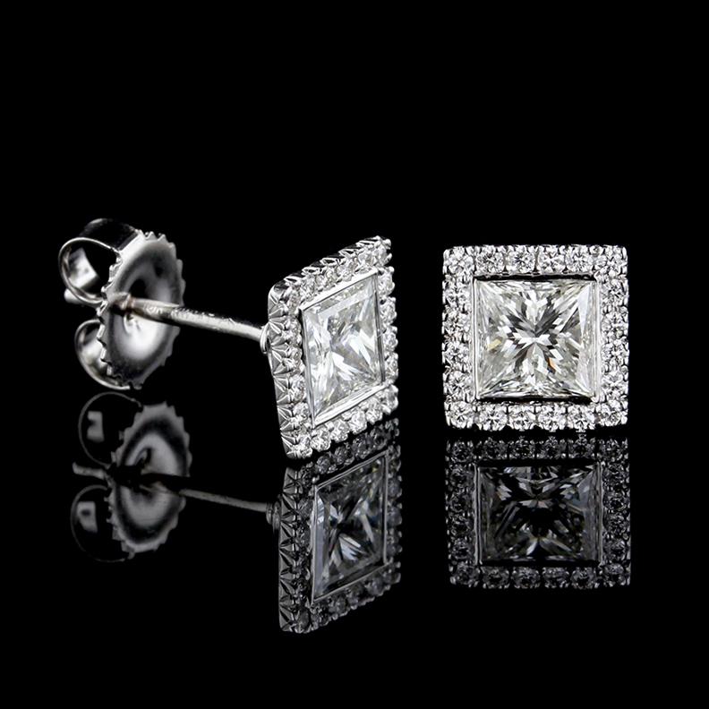 Kwiat 18K White Gold Diamond Halo Earrings. The earrings are bezel set with two
princess cut diamonds, approx. total wt. 1.40cts., I color, VS clarity, further set with 40
full cut diamonds, approx. total wt. .20cts., H-I color, VS clarity.