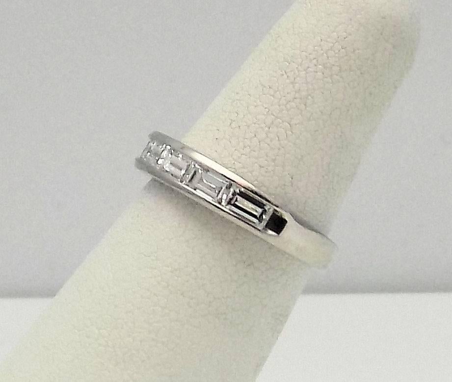 Platinum Channel Set Wedding Ring with 7 Baguette Diamonds  1.00 Carat Total Weight VVS, F-G. Size 5.75. Signed: KWIAT. 3.2 DWT or 4.97 Grams. 