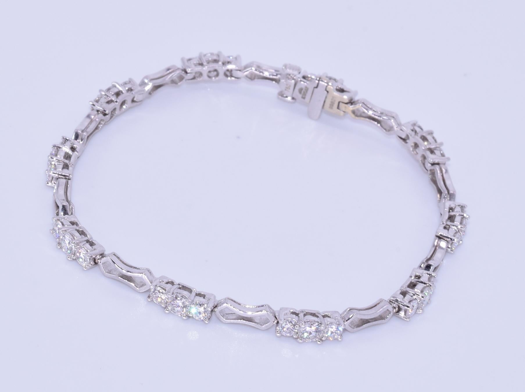 18k White Gold Diamond Bracelet, Signed Kwiat

This diamond bracelet is from the Crescent Collection with 30 round brilliant diamonds totaling 2.94 carats, GH/VS2-SI1 mounted in 18k white gold.  The bracelet is 6.75 inches in length.  The original