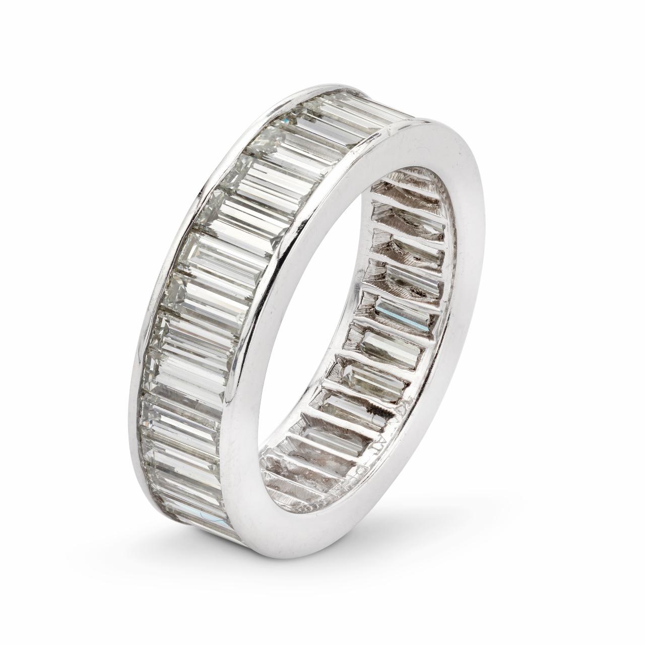 Designed by Kwiat, platinum eternity band composed of thirty two (32) channel set straight baguette cut diamonds totaling 4.80 carats, graded VS1 Clarity with I-J Color.  Comfortable on the finger, smooth and easy to wear alone or looks absolutely
