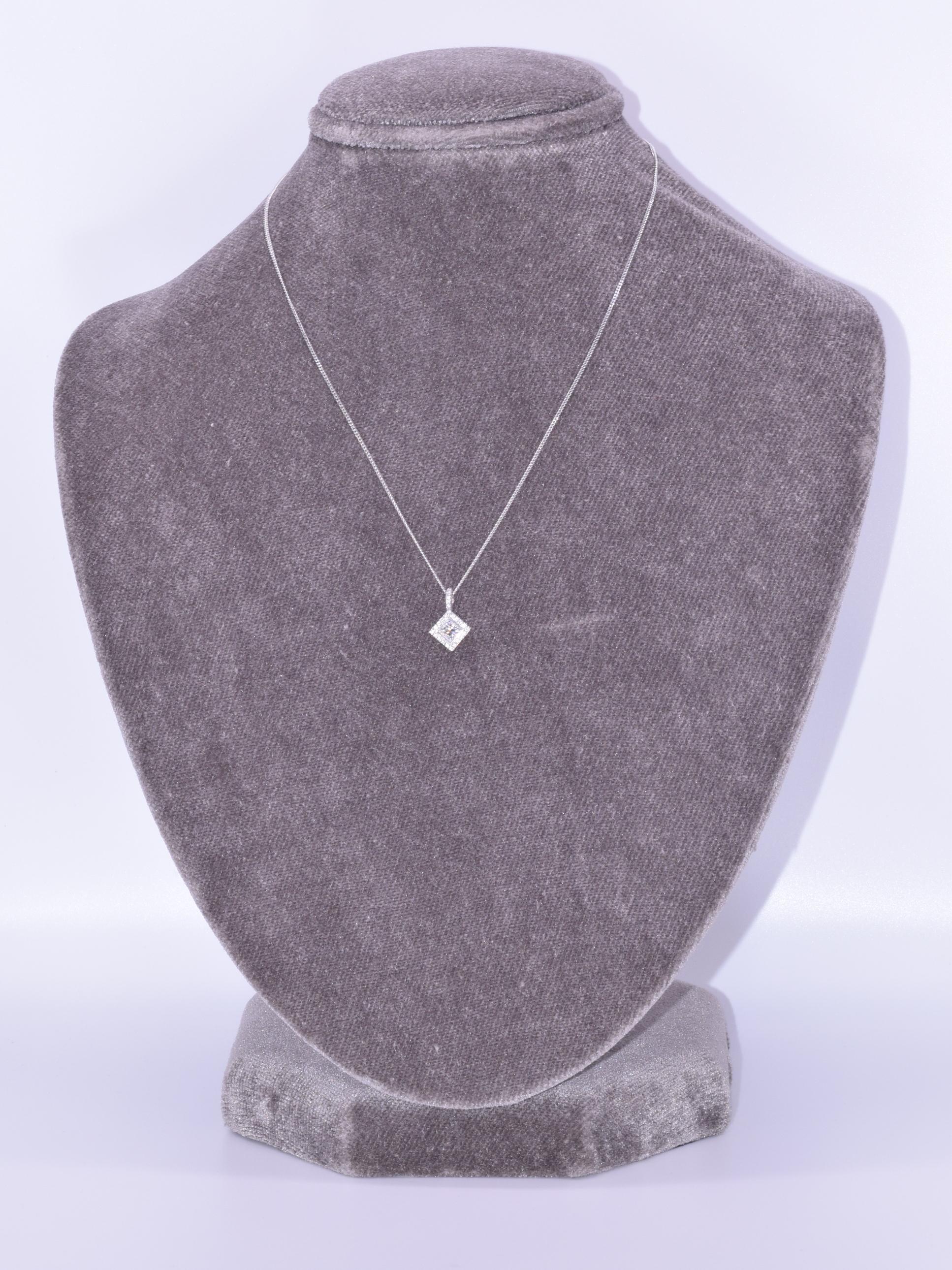 18k White Gold Diamond Pendant, Signed Kwiat

This pendant is from the Silhouette Collection with  one princess cut and 25 round brilliant diamonds totaling 0.65 carat, HI/VS mounted in 18k white gold.  The necklace is 16 inches in length.  The