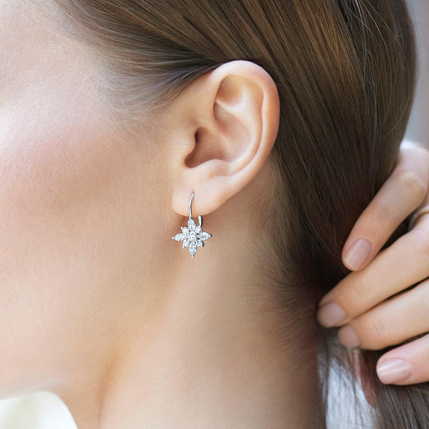 These beautiful earrings from the Kwiat Star Collection feature 1.85 carat total weight in round and marquise diamonds set in platinum. The round diamonds ae surrounded by marquis diamonds to form a beautiful star shape. Each star dangles from 18