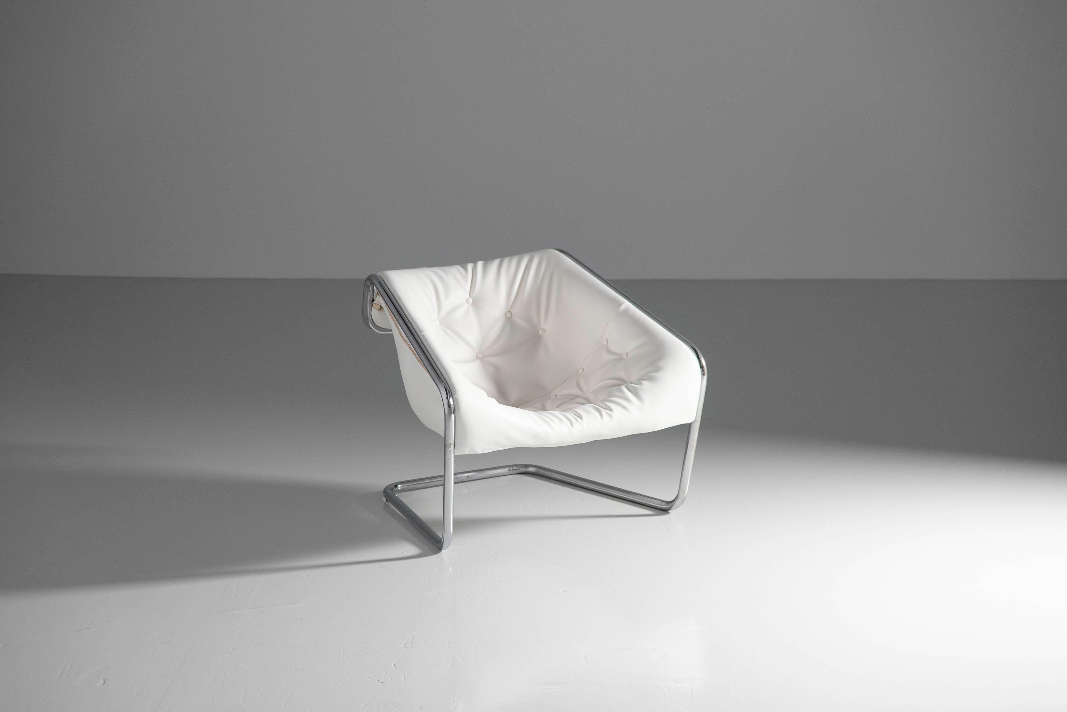 Comfortable so called 'Boxer' lounge chair designed by Kwok Hoi Chan and manufactured by Steiner, France 1971. The chair has a tubular chrome plated metal frame which is very strong and firm, and it supports a white seat in leatherette. The big seat