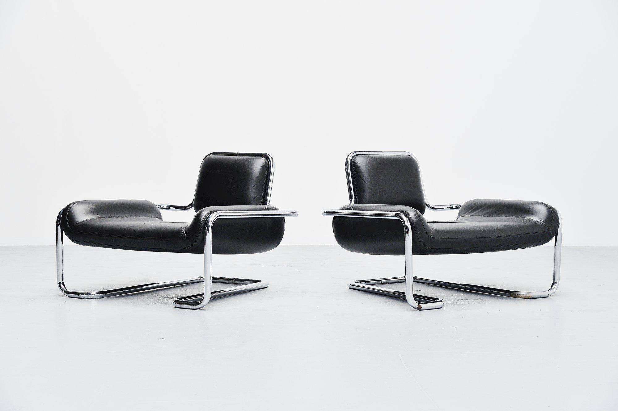 Rare low lounge chair pair designed by Kwok Hoi Chan and manufactured by Steiner, France 1971. These fantastic shaped lounge chairs have a thick chrome-plated tubular metal frame and black leather upholstered seat. The chairs seat very nice and