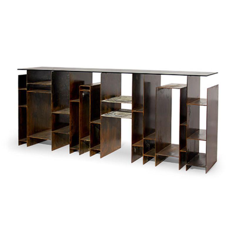 The incredible Beijing’ skyline inspired our designers to create Kyan console table, a strong and edgy furniture piece. Featuring a top in bronze glass and a base in iron with acid reaction finish, this modern console tells a story with an