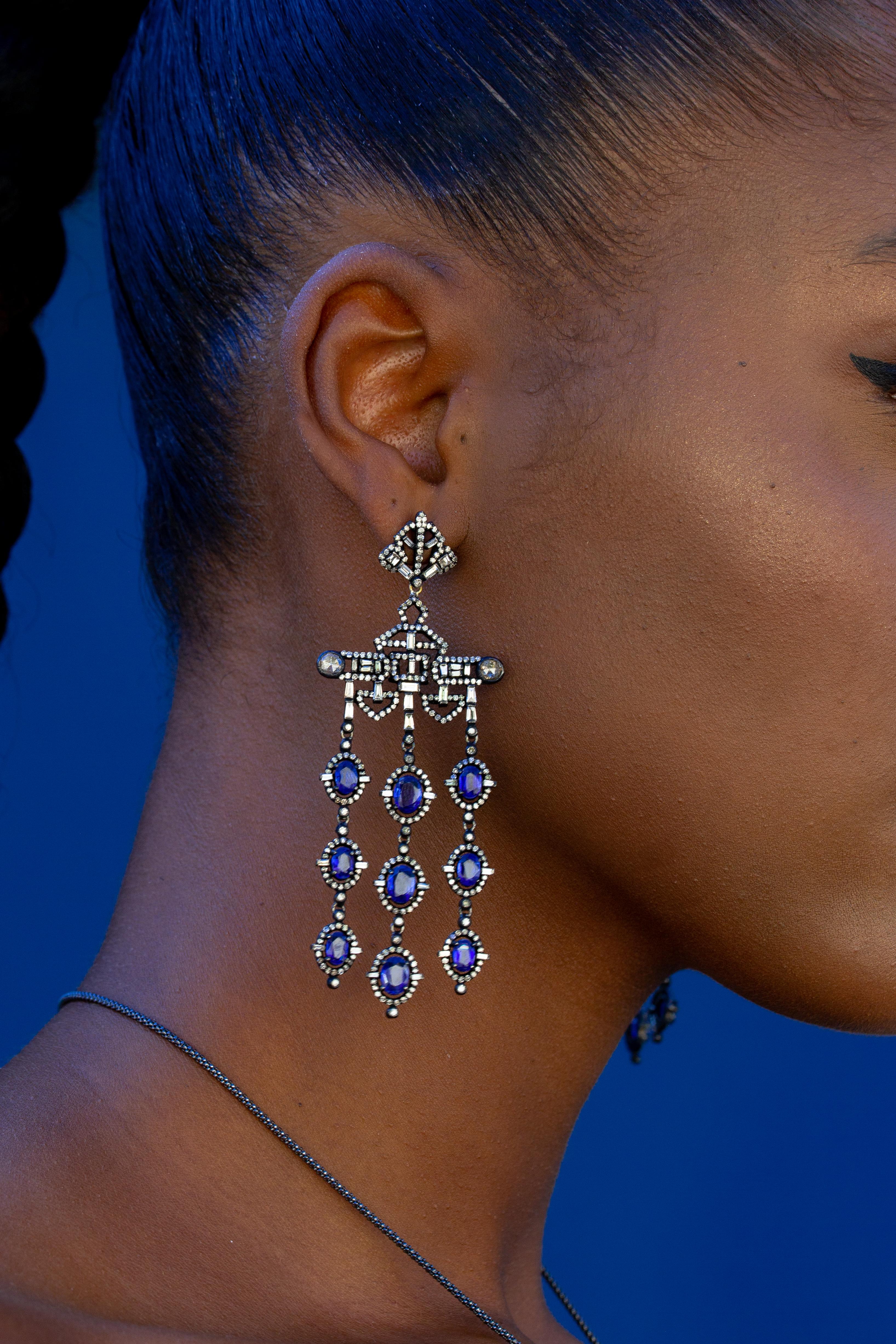 Evoking royalty, this chandelier style earring features Kyanites, accented with diamonds in oxidized silver. The combination of the cool-toned kyanite and the sparkle of the diamonds makes this earring set a true timeless classic.