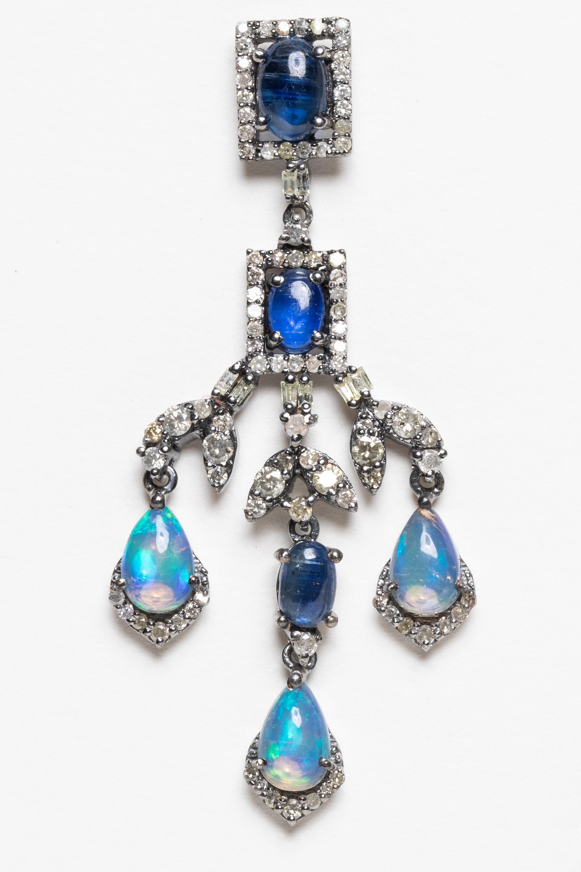 A stunning pair of chandelier earrings with 6 oval, cabochon Kyanite stones, 6 pear-shaped opals and round, brilliant cut diamonds throughout the setting.  Set in sterling silver with 18K gold posts for pierced ears.  Carat weight of diamonds is