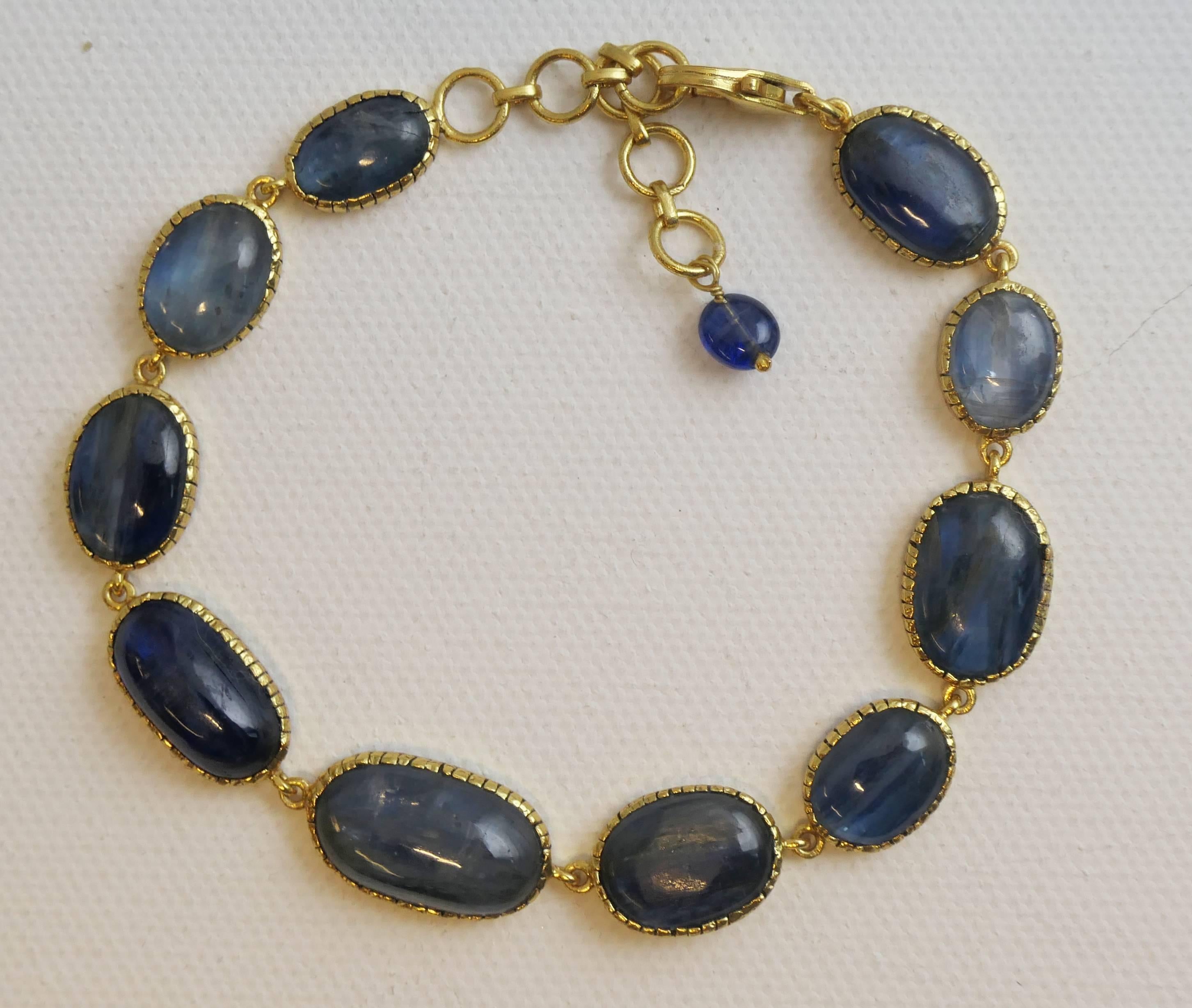 This single strand Kyanite bracelet is 7.5 inches long with an additional 1.5 inch of extension chain and it has a hook clasp. The cabochon kyanite are of varying shapes and sizes, ranging from 10 to 18mm in diameter.