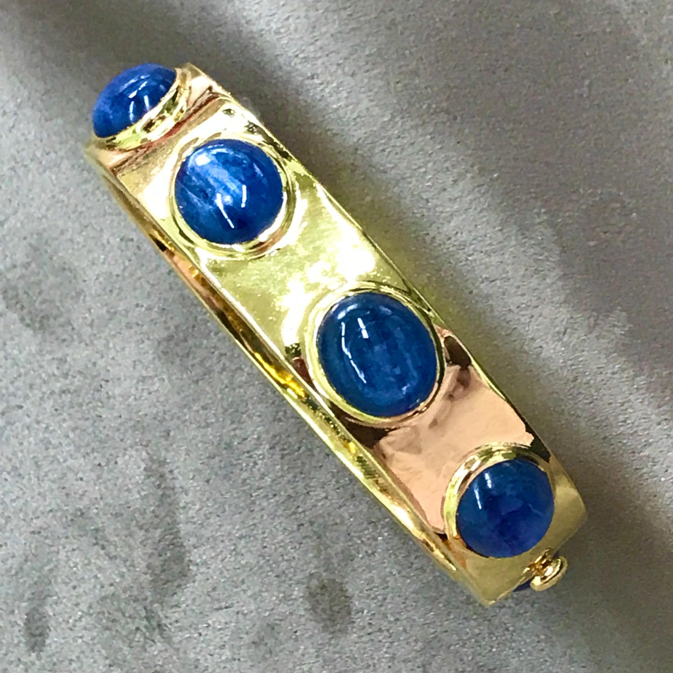 An extremely stylish, substantial and elegant hinged cuff, bezel set with 8 cabochon Kyanite of a lovely iridescent dark blue colour.  We love the proportions of this cuff - discreet enough to be worn everyday, yet striking enough to be noticed in