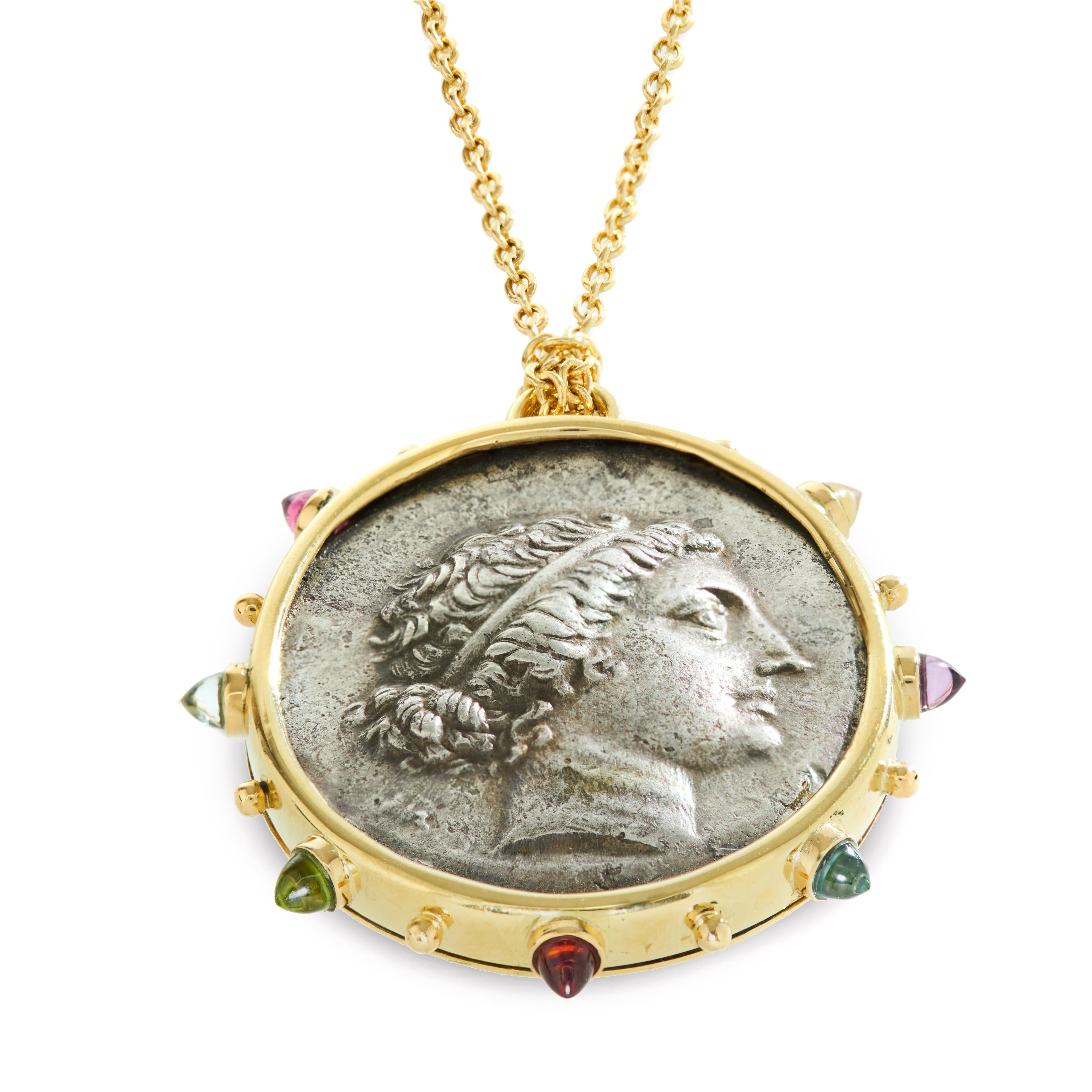 This DUBINI coin necklace from the 'Empires' collection features authentic silver coin minted in Aeolis, Kyme circa 155-143 B.C. set in 18K gold with citrine, amethyst, swiss topaz, garnet, peridot, sky topaz and rhodolite bullet