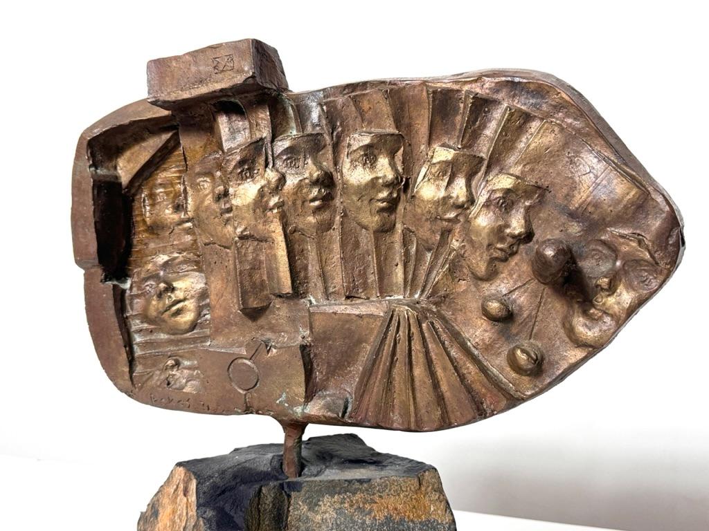 Kyriakos Rokos (b 1945)
Bronze sculpture on stone base
1971

Abstract bronze sculpture by renowned Greek artist Kyriakos Rokos
Cast relief with perpetual faces and a protruding finger
Mounted to stone base
Signed and dated lower left  

16 inch