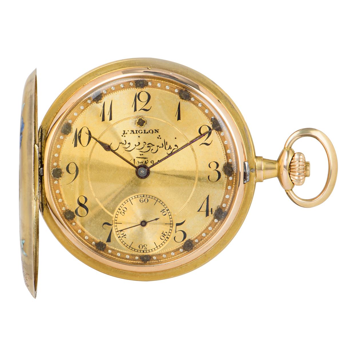 A unique 14k Yellow Gold and Enamel Vintage Pocket Watch, champagne dial with arabic numbers, small seconds at 6 0'clock, a fixed 14k yellow gold bezel, a 14k yellow gold case featuring an enamel illustration, a 14k yellow gold inner cuvette case,