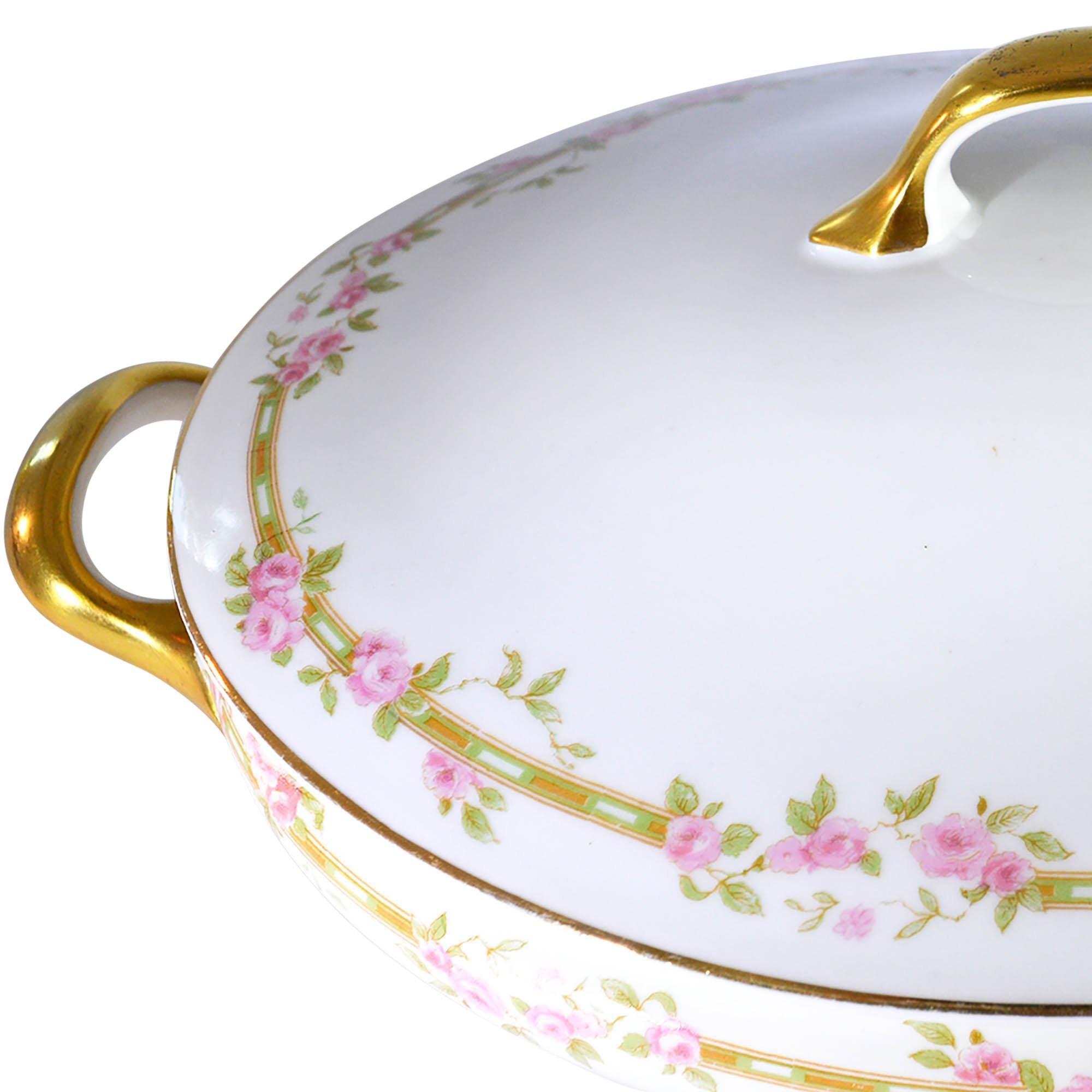 White lidded serving dish with delicate rose accents and glimmering gold handles. This serving dish is sure to make any meal feel special.