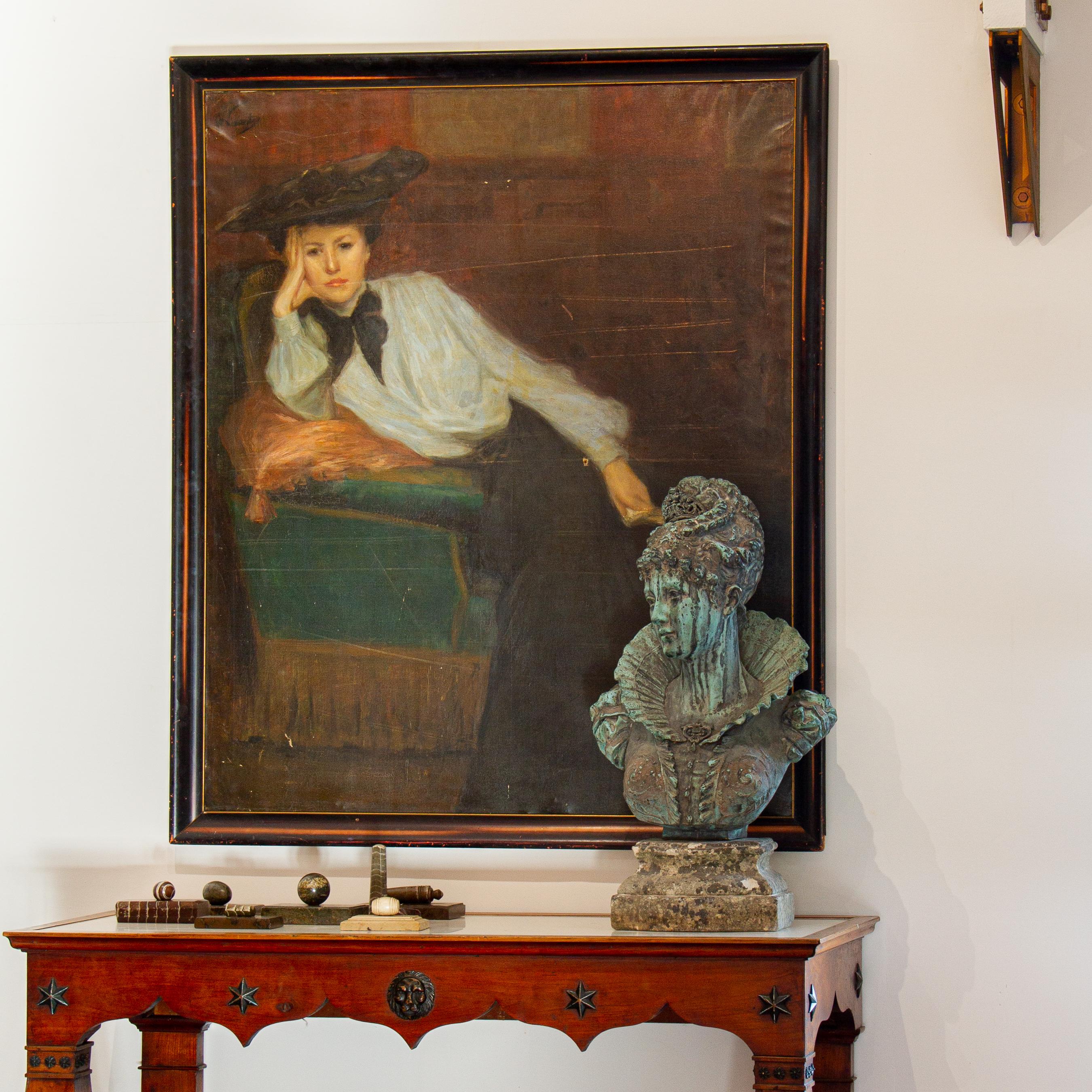 A large 19th century painting on original untouched canvas, with original stretcher and frame of an elegant, pensive lady inclining against a vibrant green chair. Signed upper right hand corner A. Vivante and titled 'Interior with young woman in