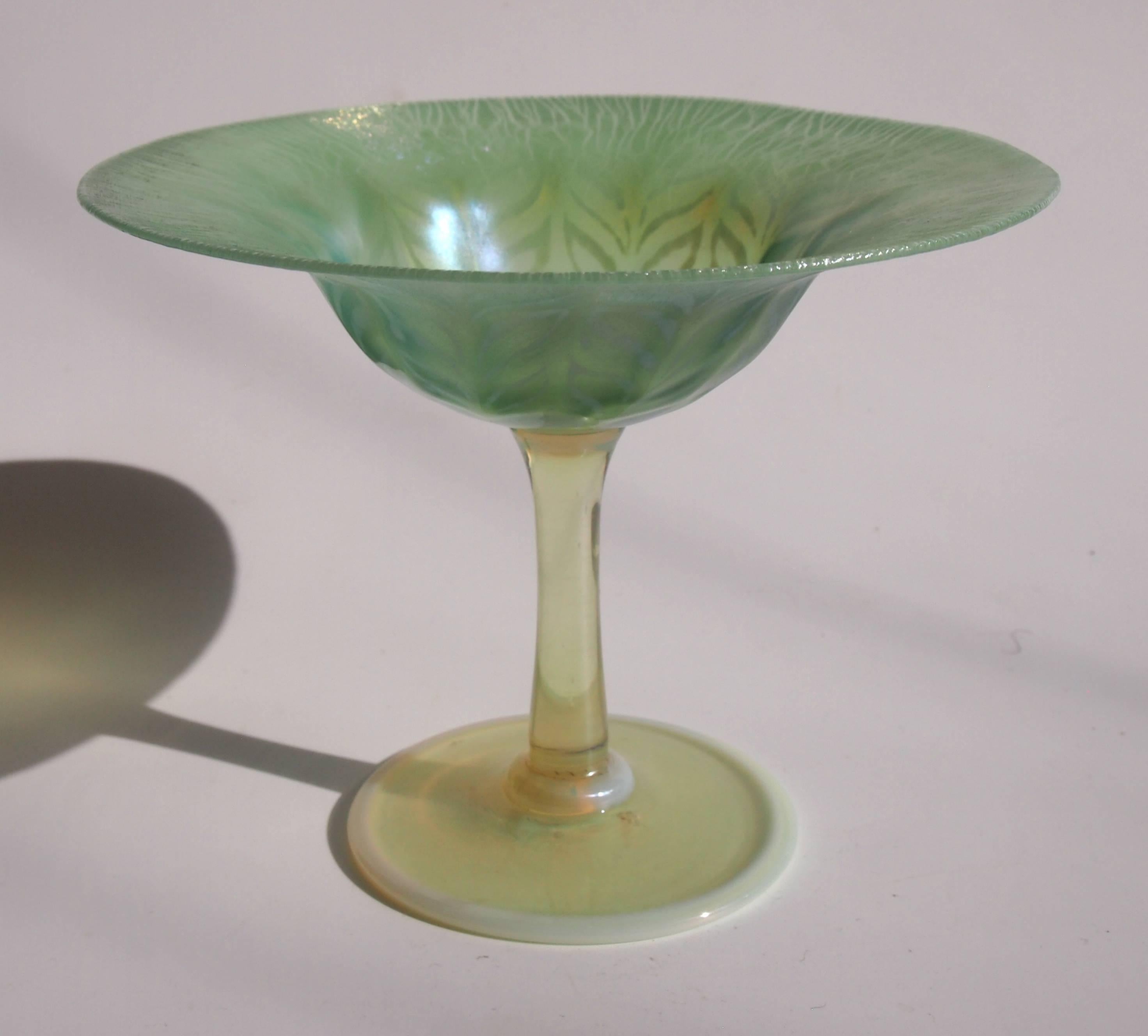 A superior Louis comfort Tiffany green and opal Pastel Favrile Compote/Tazza with an opal yellow stem and foot. Beautifully signed '1701' and 'L.C.Tiffany Favrile' -on the base. See picture 8. The green pastel has a slightly onion skinned effect to