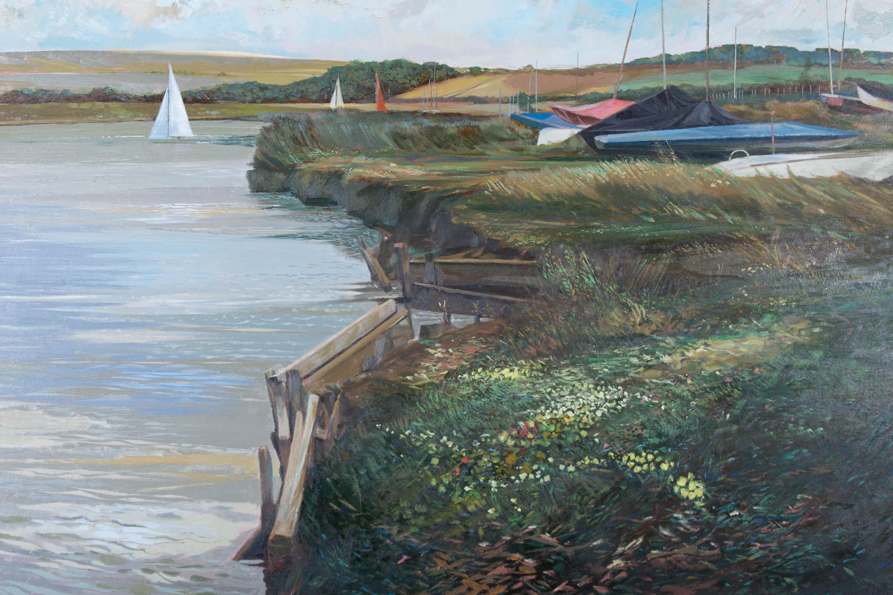 A fine and accomplished oil painting, depicting a view with boats in Piddinghoe, Sussex. Monogrammed and dated to the lower right-hand corner. There is a 'Sussex Artists and Photographers Exhibition 1987' label on the reverse. There are other labels