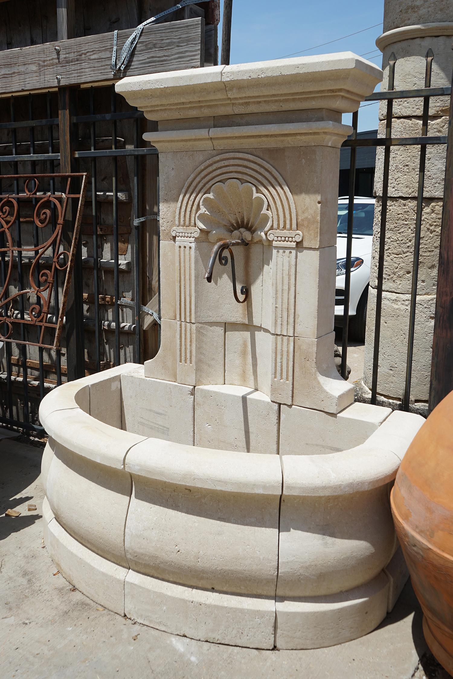 Here we have a hand carved limestone wall fountain from France with a shell design and semi-circular basin.

Origin: France

Measurements: 6'10