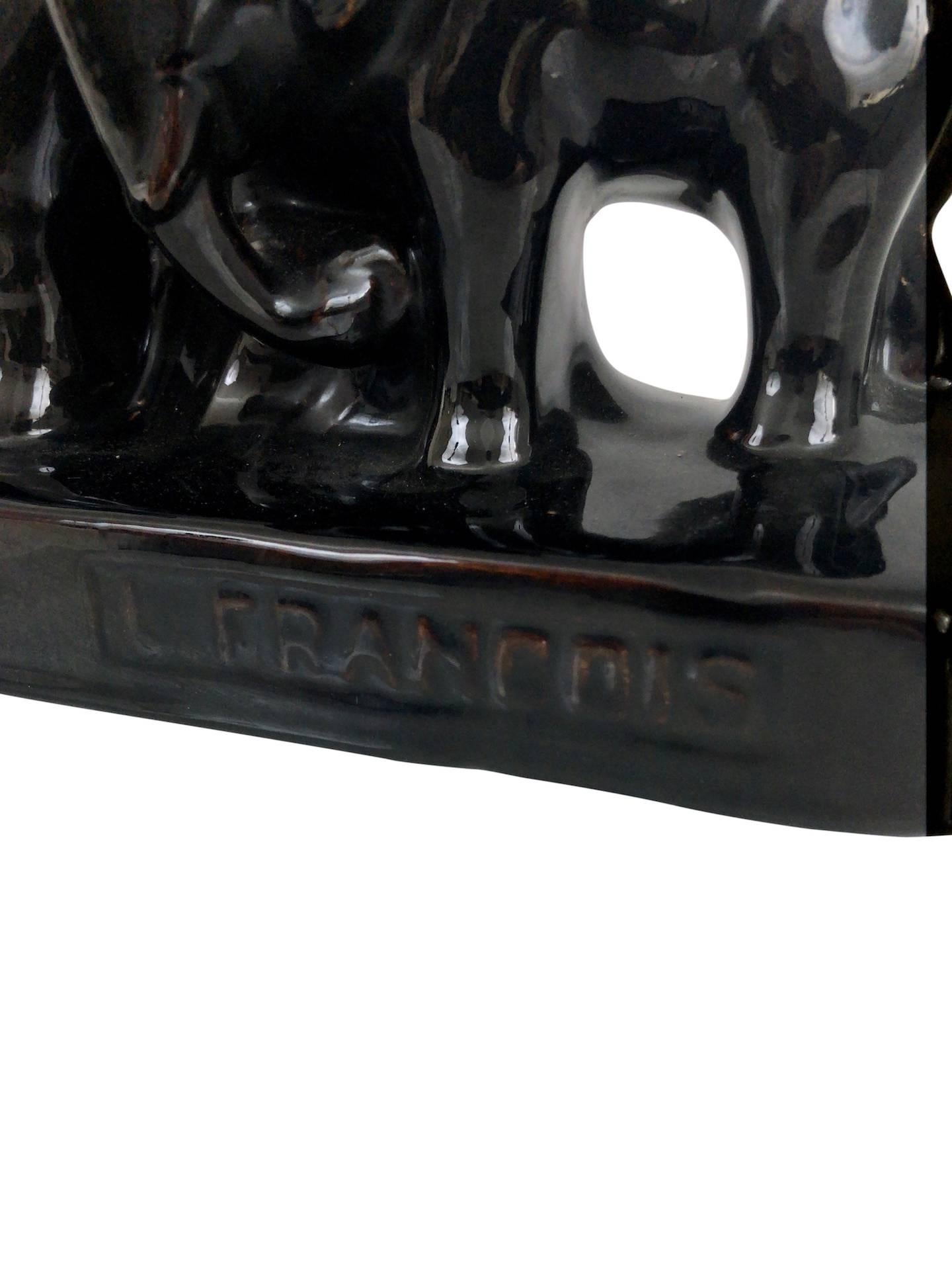 Black glazed ceramic elephants
signed: L. Francois
France, 1930s

Dimensions:
Width 35 cm
Height 23 cm.
Depth: 9 cm