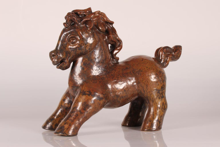 Huge stoneware figurine/sculpture of a young lively horse no. 535 designed by Gertrud Kudielka (1896-1984) and manufactured by L. Hjorth ceramic workshop on the island Bornholm, Denmark

The figurine is decorated with red-brown and ocher colored