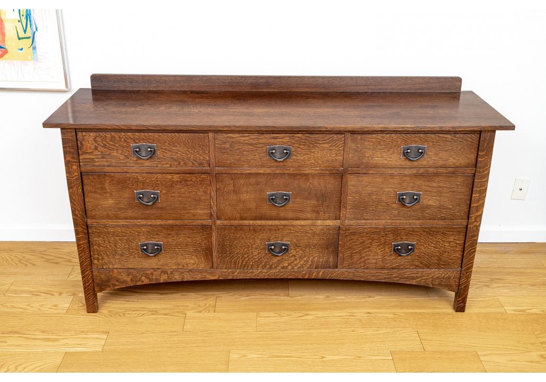 L. & J. G. Stickley misson style oak master dresser with 9 drawers, short backsplash, arched apron, dark copper hammered hardware and rests on square legs.
Dimensions: 66 1/2