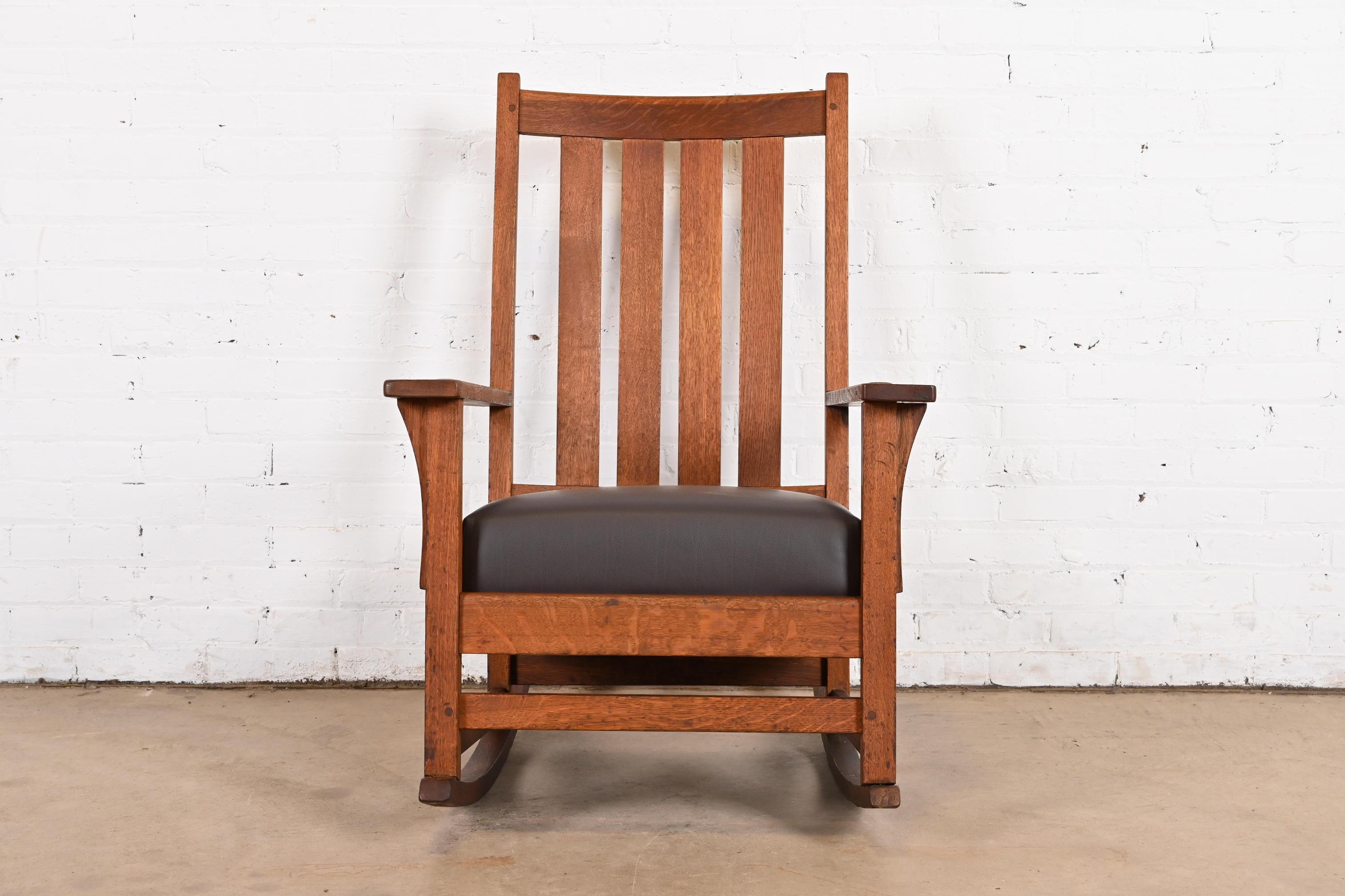 A gorgeous Mission oak Arts & Crafts rocker

By L. & J.G. Stickley

USA, Circa 1900

Solid quarter sawn oak, with brown leather seat.

Measures: 26.5