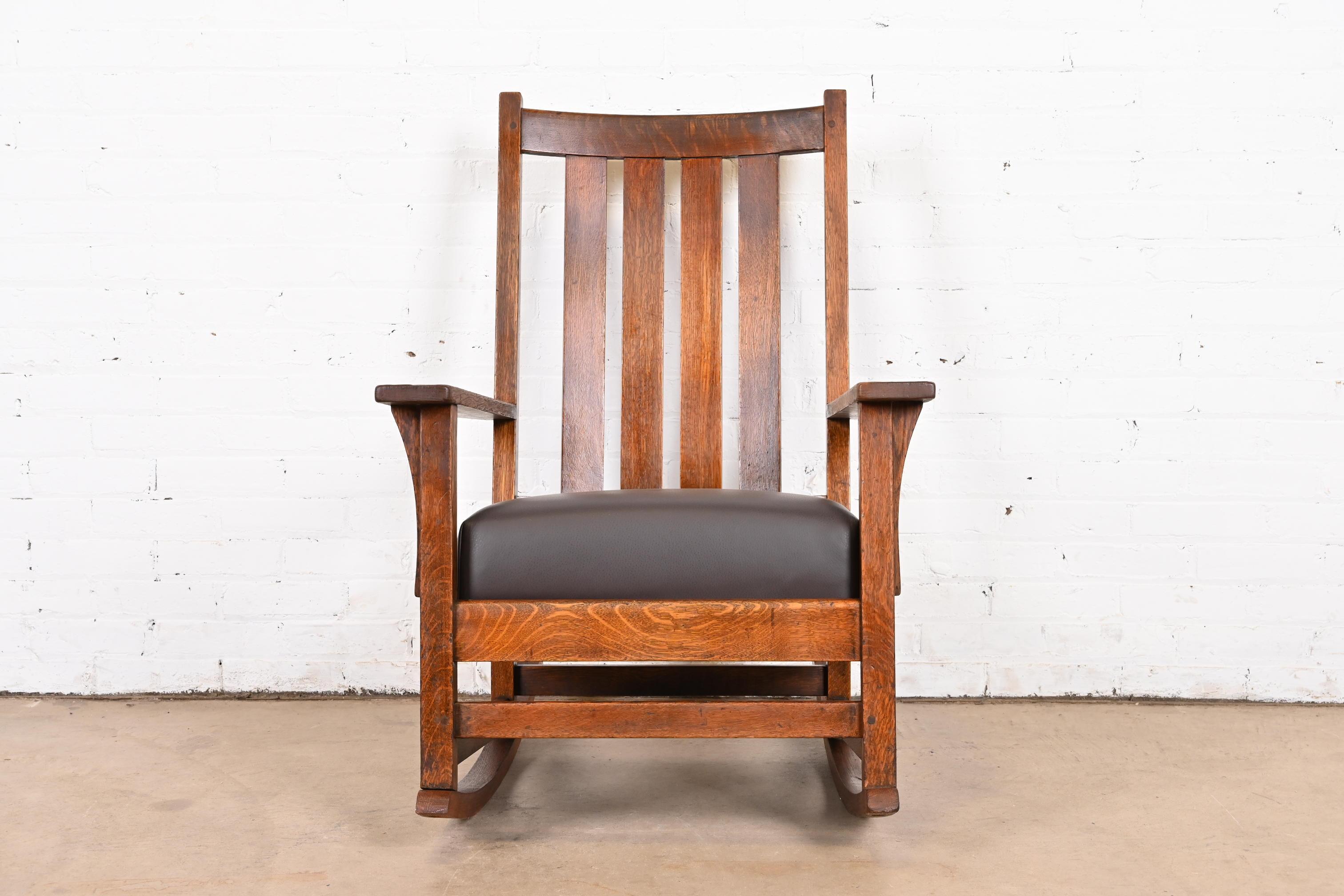 A gorgeous Mission oak Arts & Crafts rocker

By L. & J.G. Stickley

USA, Circa 1900

Solid quarter sawn oak, with brown leather seat.

Measures: 26.5