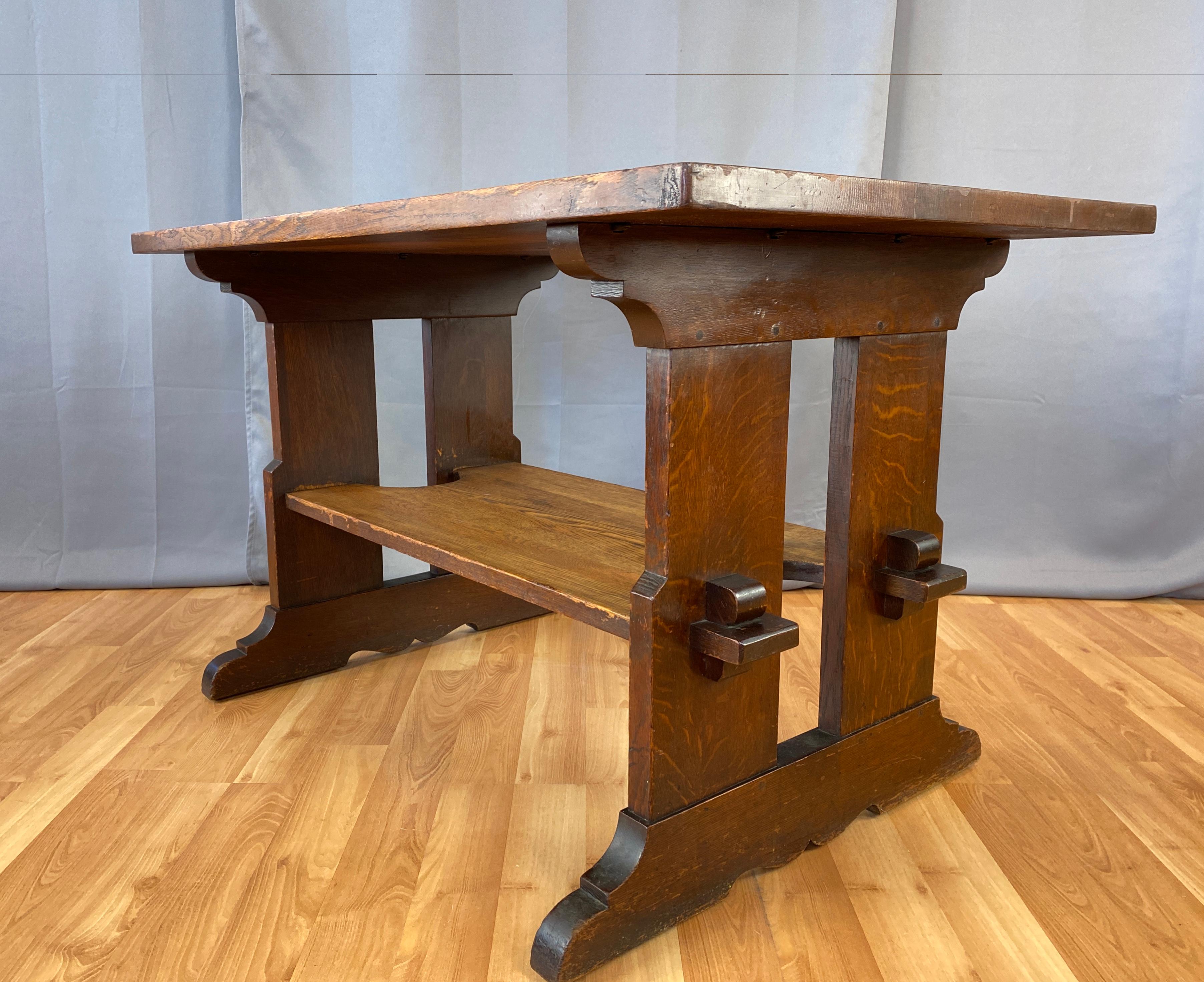 Offered here is a handsome L & JG Stickley trestle library table with lower shelf and exposed keyed tenons.