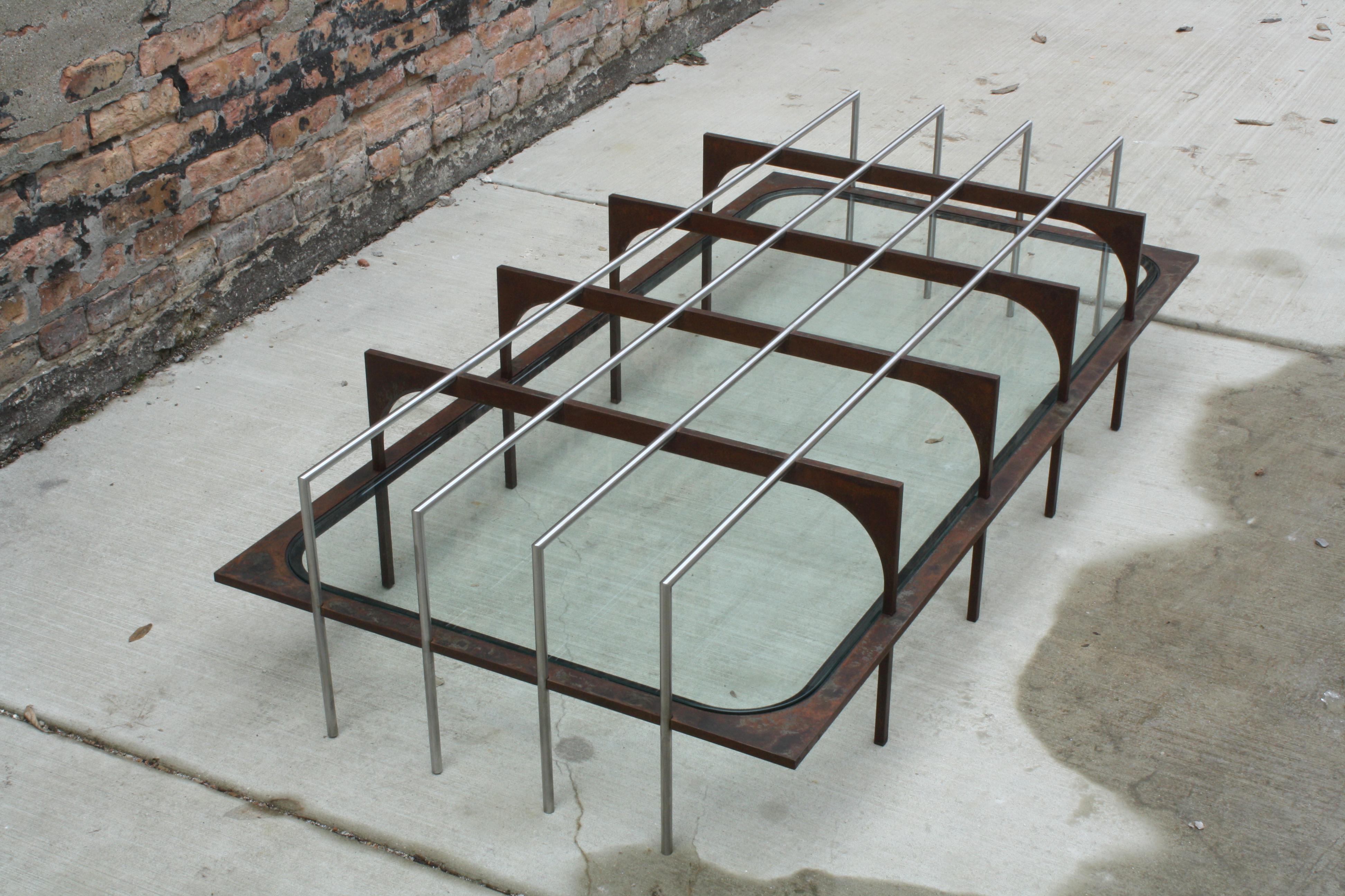 L Low Table by Laylo Studio
Limited Edition
Dimensions: D 76.2x W 152.4 x H 35.5 cm.
Materials: Weathered steel, stainless steel, glass, flocking.

Inspired by the interplay of urban decay and fleeting reflections, our design captures the haunting