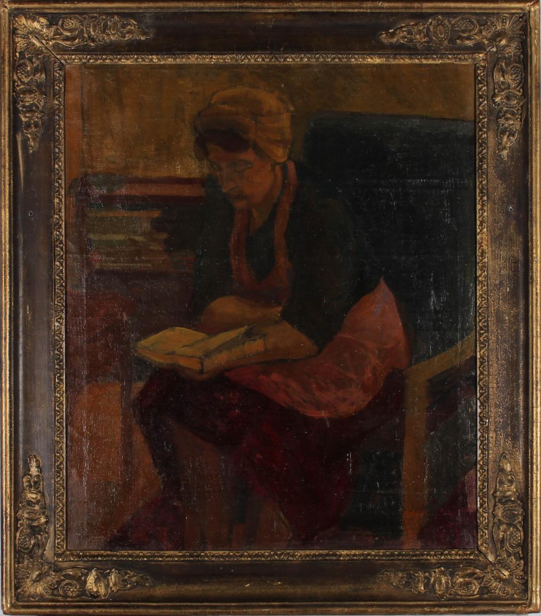 A truly beautiful early 20th Century oil, capturing a frank and domestic moment. A woman, in an apron and cap, takes a moment of rest from her daily toils, to read from a book. The composition and lighting give much to the narrative as she leans