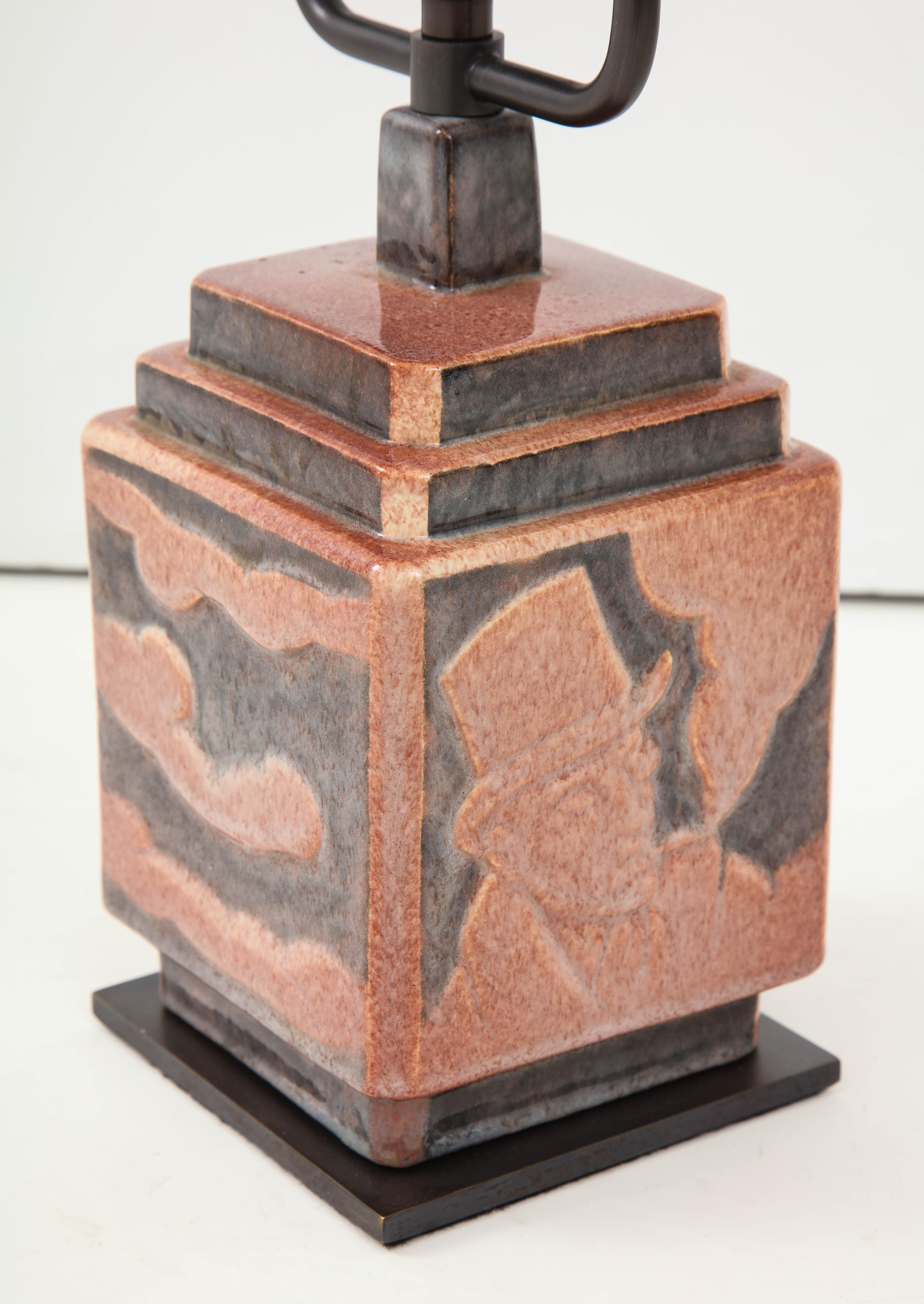 Dramatic and highly stylized ceramic table lamp by L. Rossat for Marcel Guillard, France, circa 1930s. 

Each face on the lamp's square, cubic base depicts highly graphic imagery typical of the Art Deco period.

Signed on the underside. 
  
  