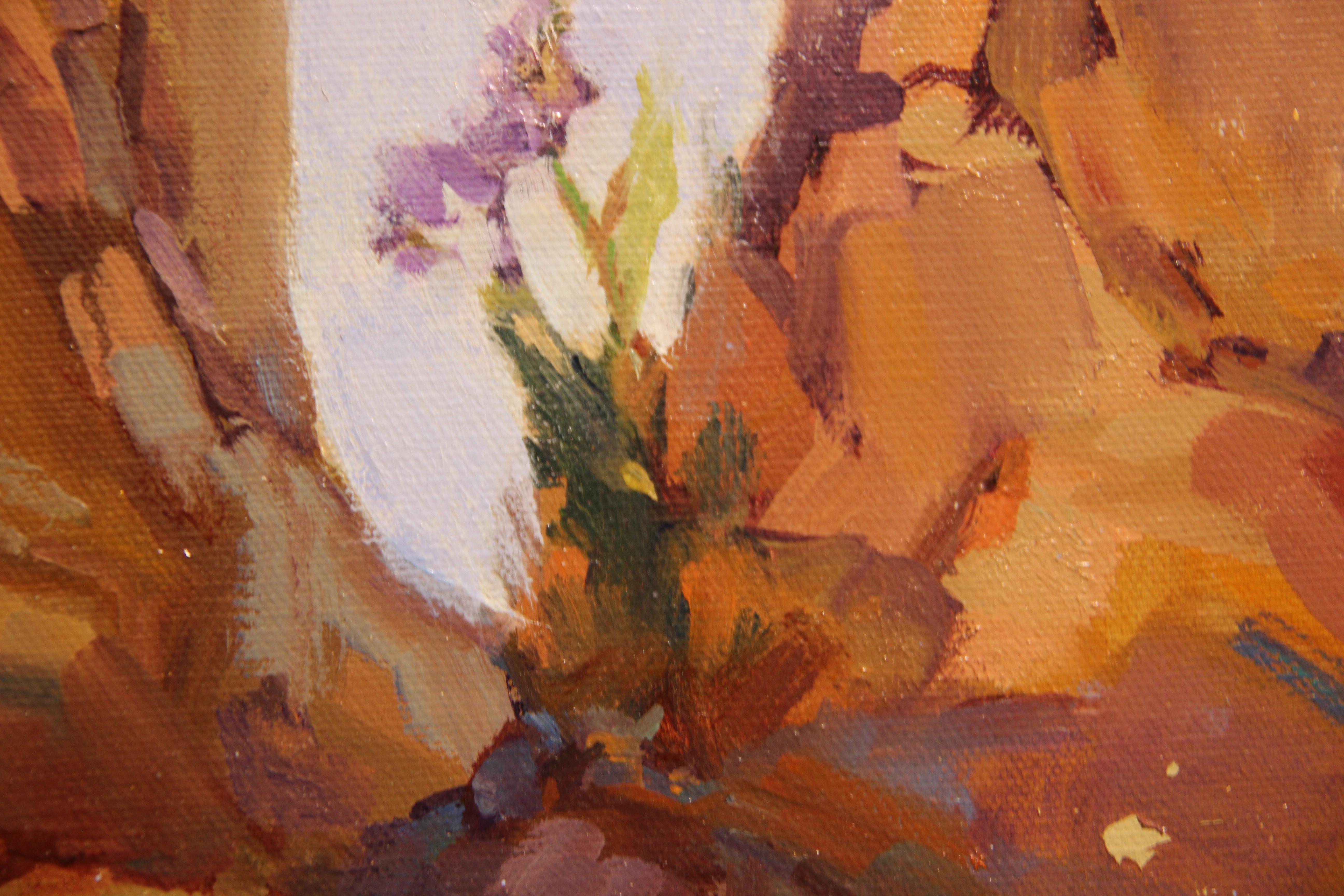 Warm toned impressionist landscape oil painting depicting rocky and arid Southwestern desert with purple flowers by artist L. Williams. Signed in lower right corner and hung in a dark wood frame. 

Dimensions Without Frame: H 20 in. x W 24 in. 