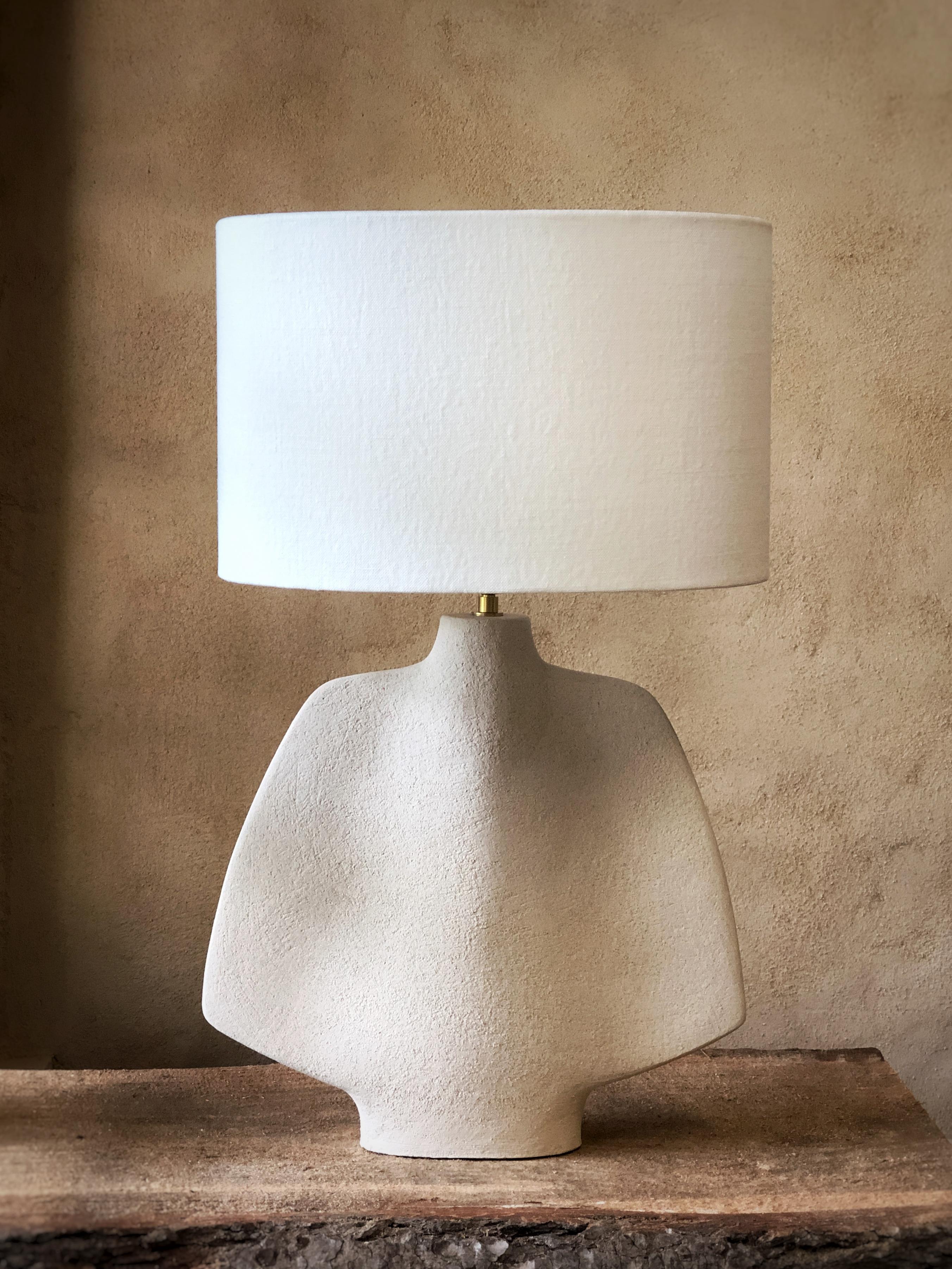 L04 Lamp by Sophie Vaidie
One Of A Kind.
Dimensions: D 24 x W 35 x H 60 cm. 
Materials: Beige brutal stoneware with fine chamotte and white linen fabric.

All our lamps can be wired according to each country. If sold to the USA it will be wired for