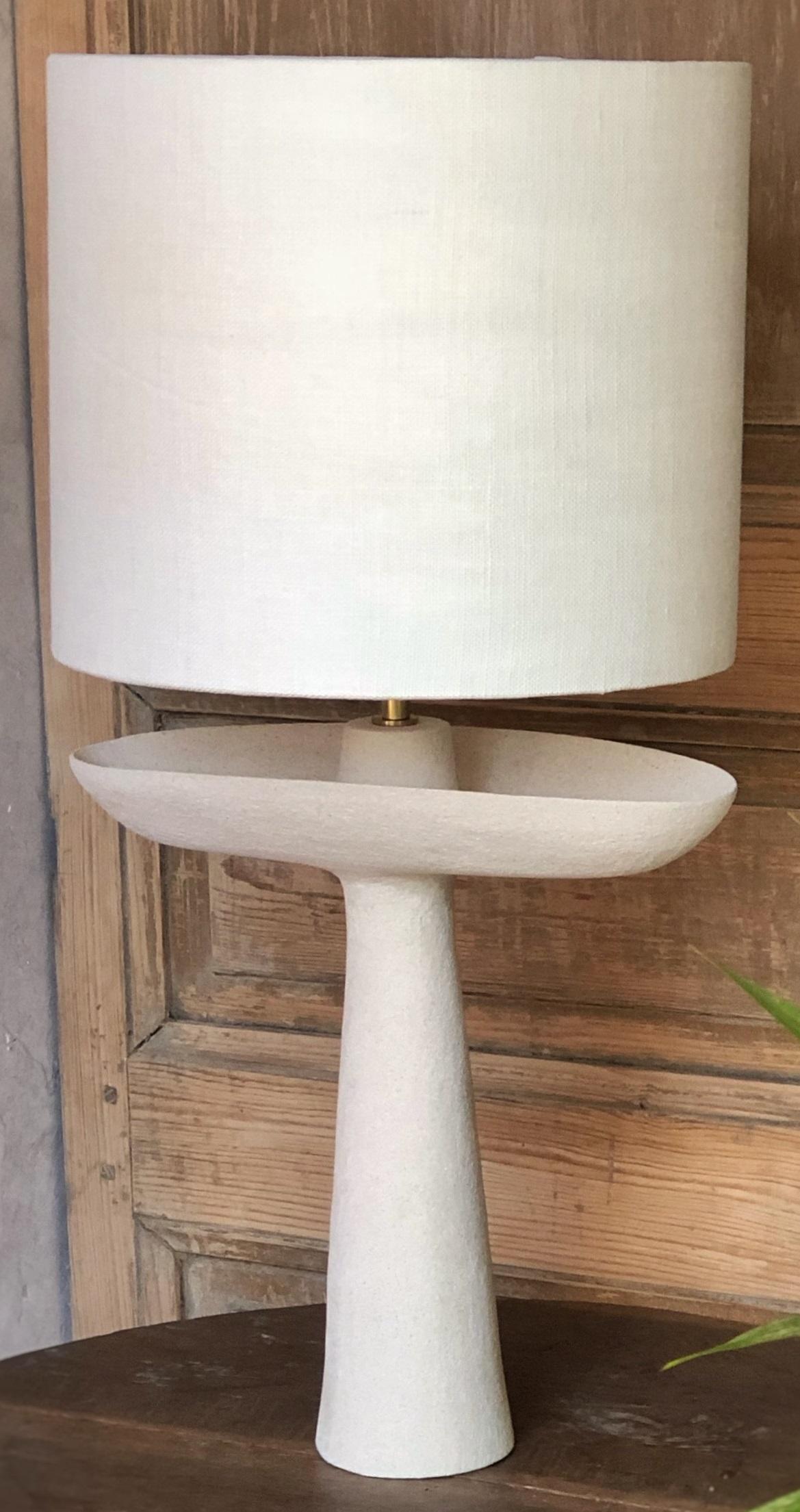 L05 Brutal Lamp by Sophie Vaidie
One Of A Kind.
Dimensions: D 28 x W 30 x H 60 cm. 
Materials: Beige brutal stoneware and white linen fabric.

All our lamps can be wired according to each country. If sold to the USA it will be wired for the USA for