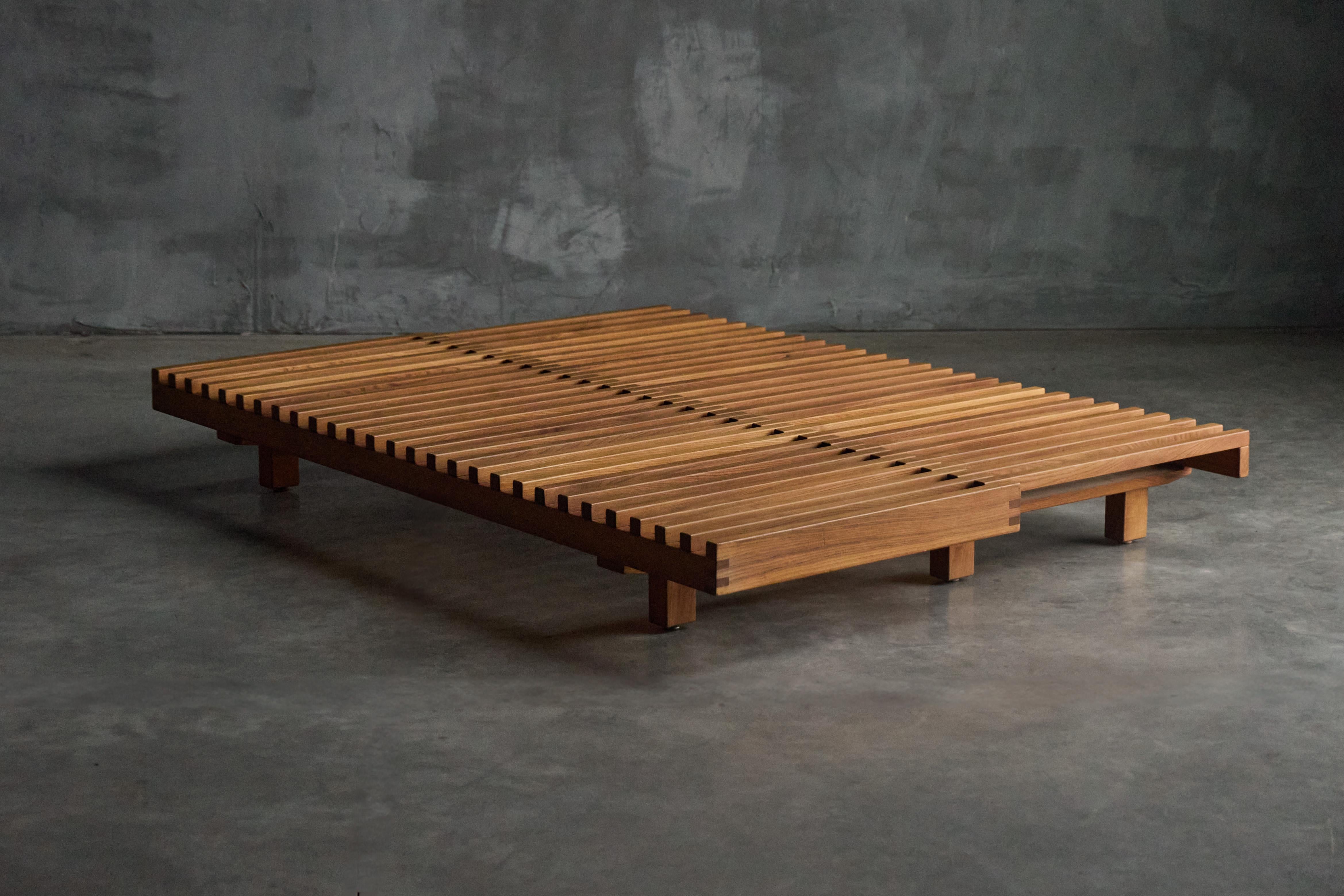 Designed in 1963, Pierre Chapo's L07 daybed is a timeless piece that seamlessly transitions from a sleek bench or single daybed into a spacious double daybed. Constructed from natural elm wood, the L07 features slatted surfaces and a clean,