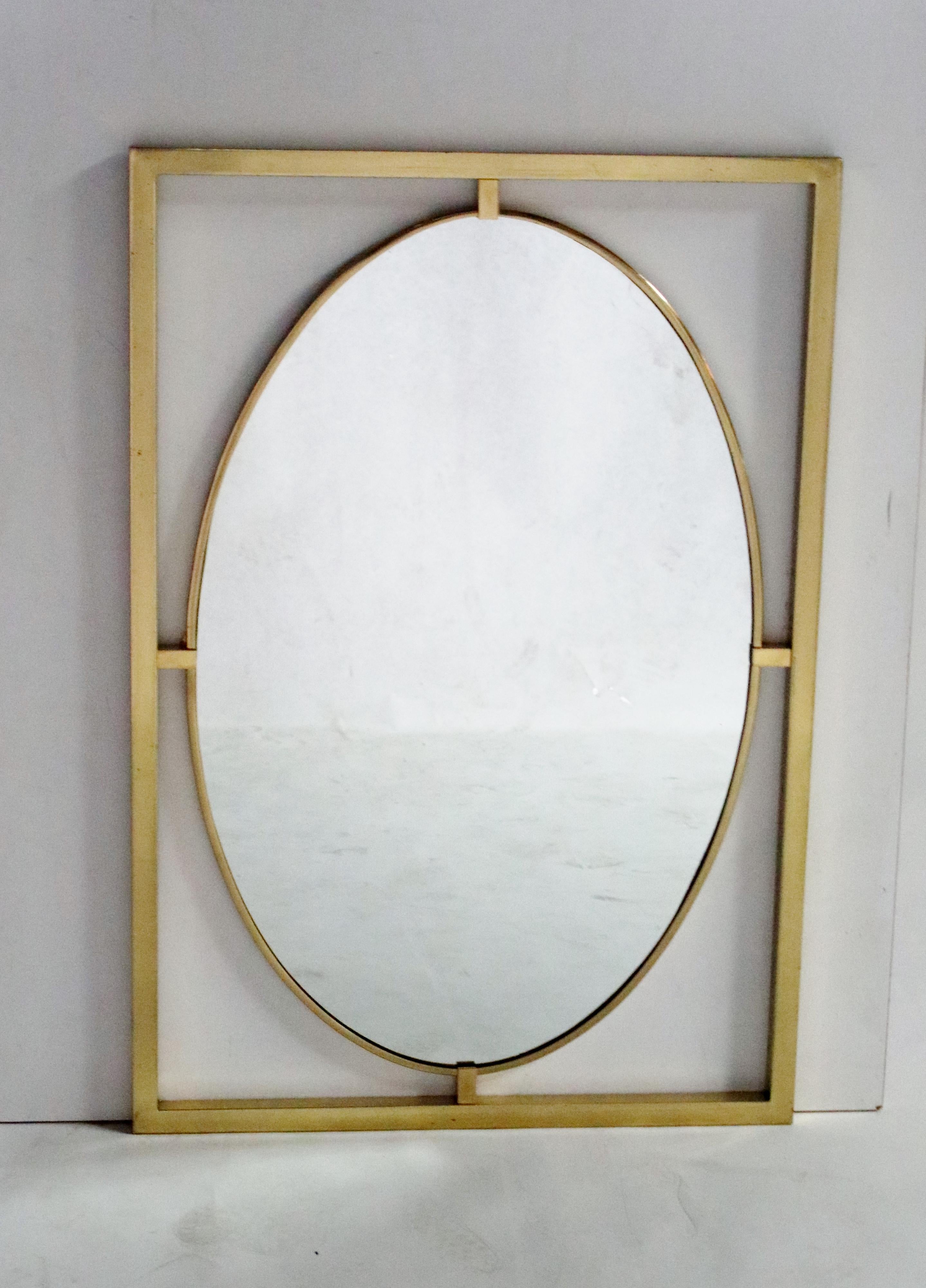Midcentury brass oval mirror framed in brass metal by La Barge. Labelled on verso.