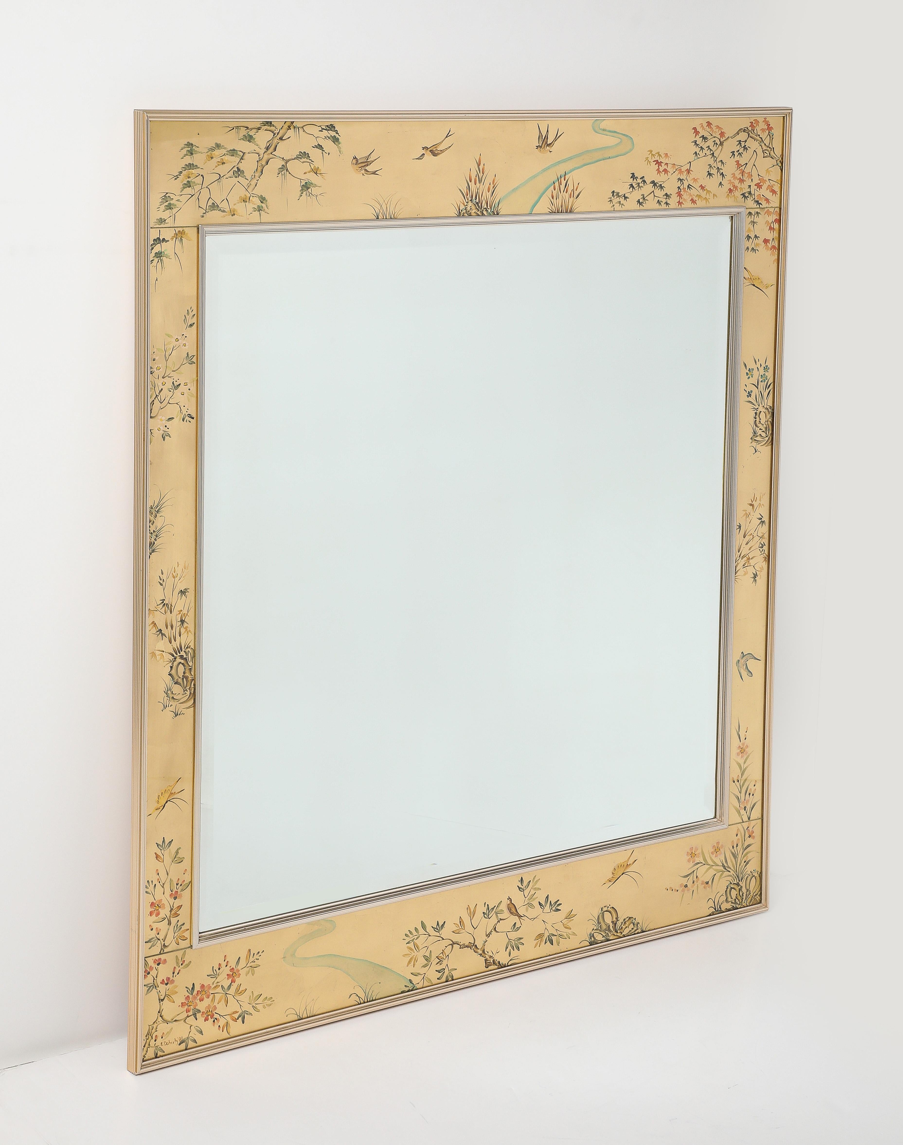 Reverse hand painted glass and gold leaf frame depicting chinoiserie themes of nature surround a large beveled edge mirror, all framed in a brass frame. La Barge.
