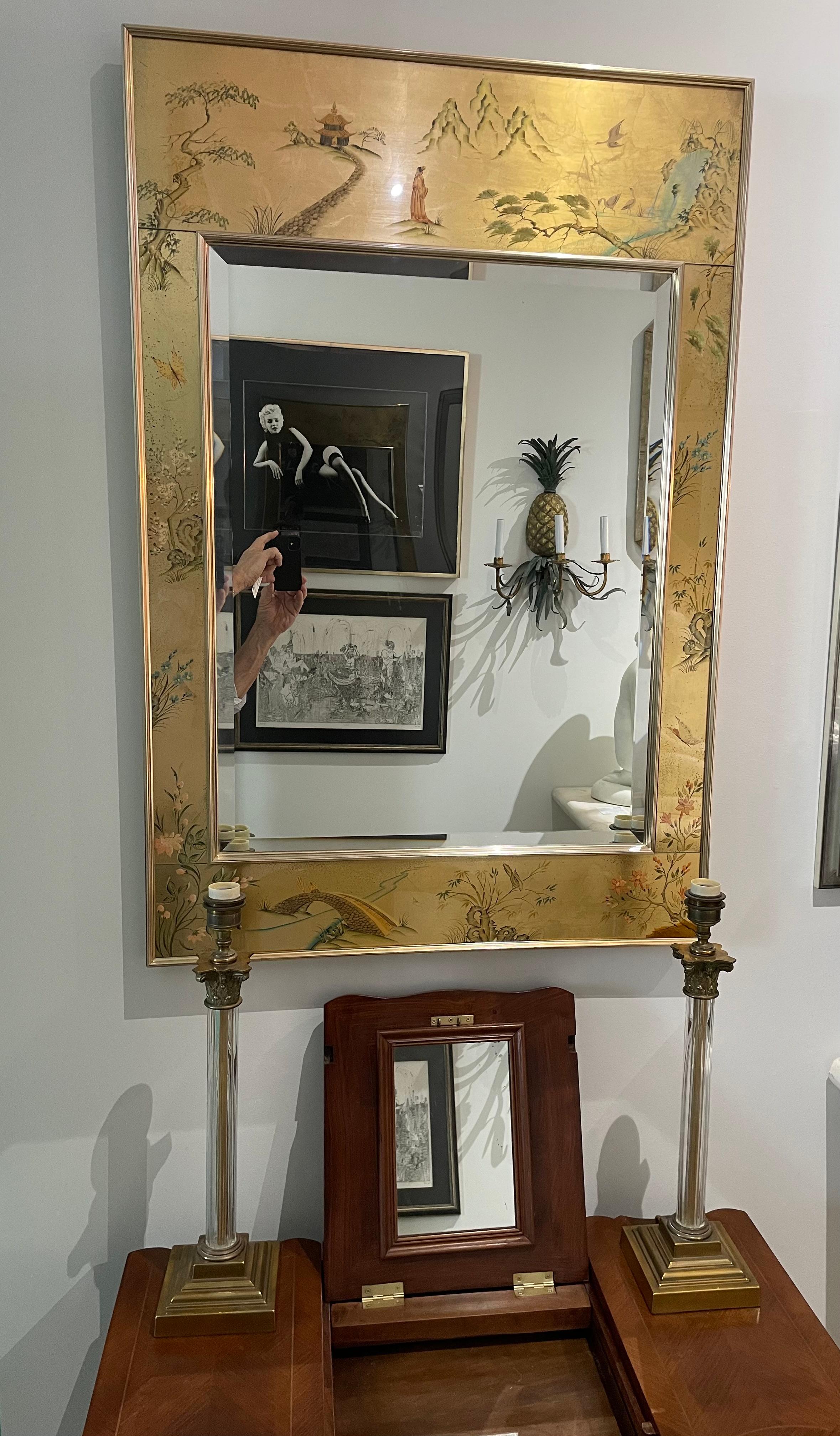 This stylish and chic LaBarge wall mirror dates to the 1970s, and was acquired from a Boca Raton estate.  The piece has an anodized aluminum frame and eglomise, hand painted panels with exotic scene of birds, flowers and bridges. 

Note:  Signed on