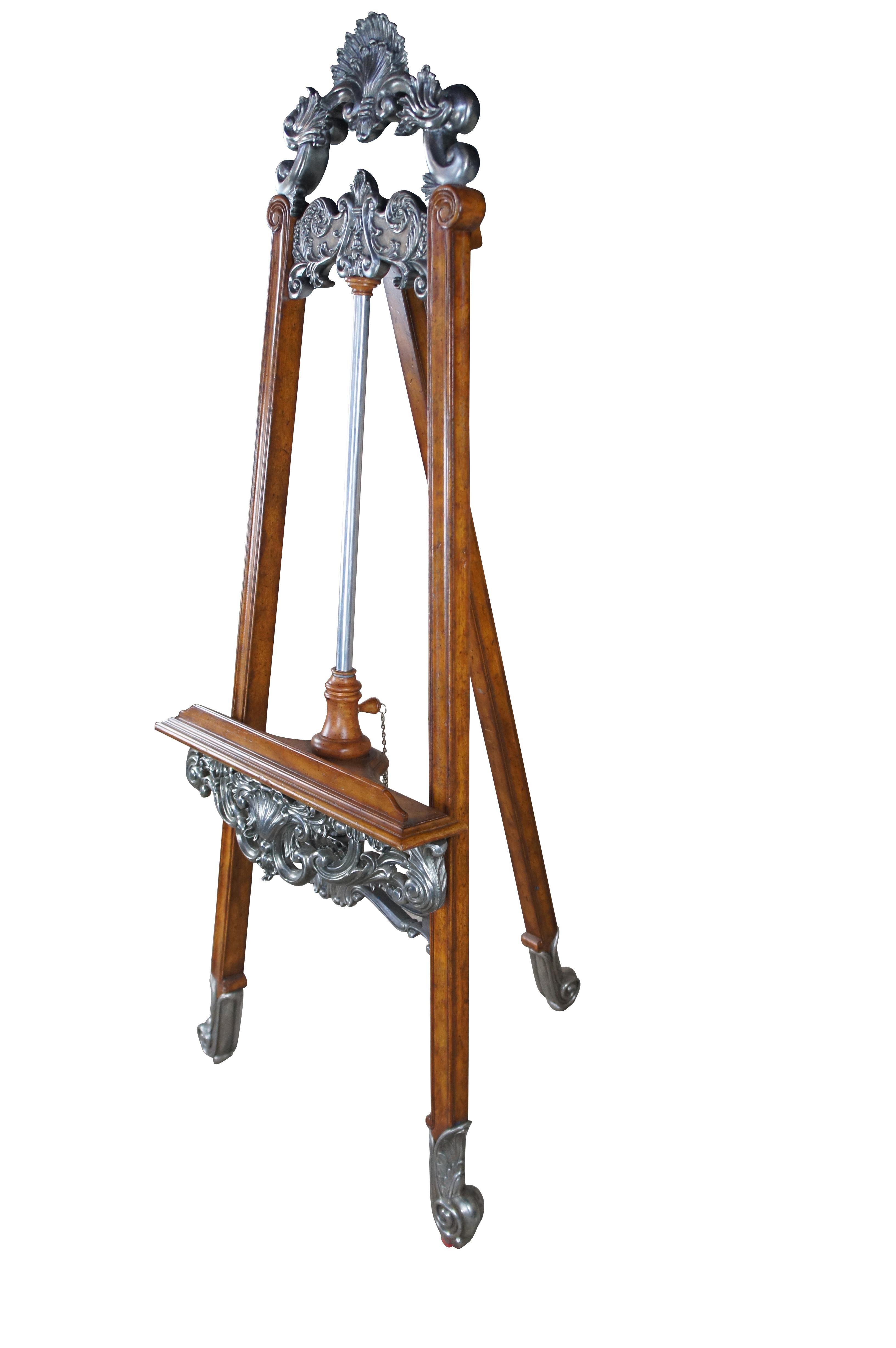 An exceptional Louis XV / Baroque Rococo inspired easel by La Barge. Features a mahogany frame with cast metal silvertone relief. The stand adjusts via latch along the back of the aluminum center. Perfect for display in any setting.

Dimensions:
28