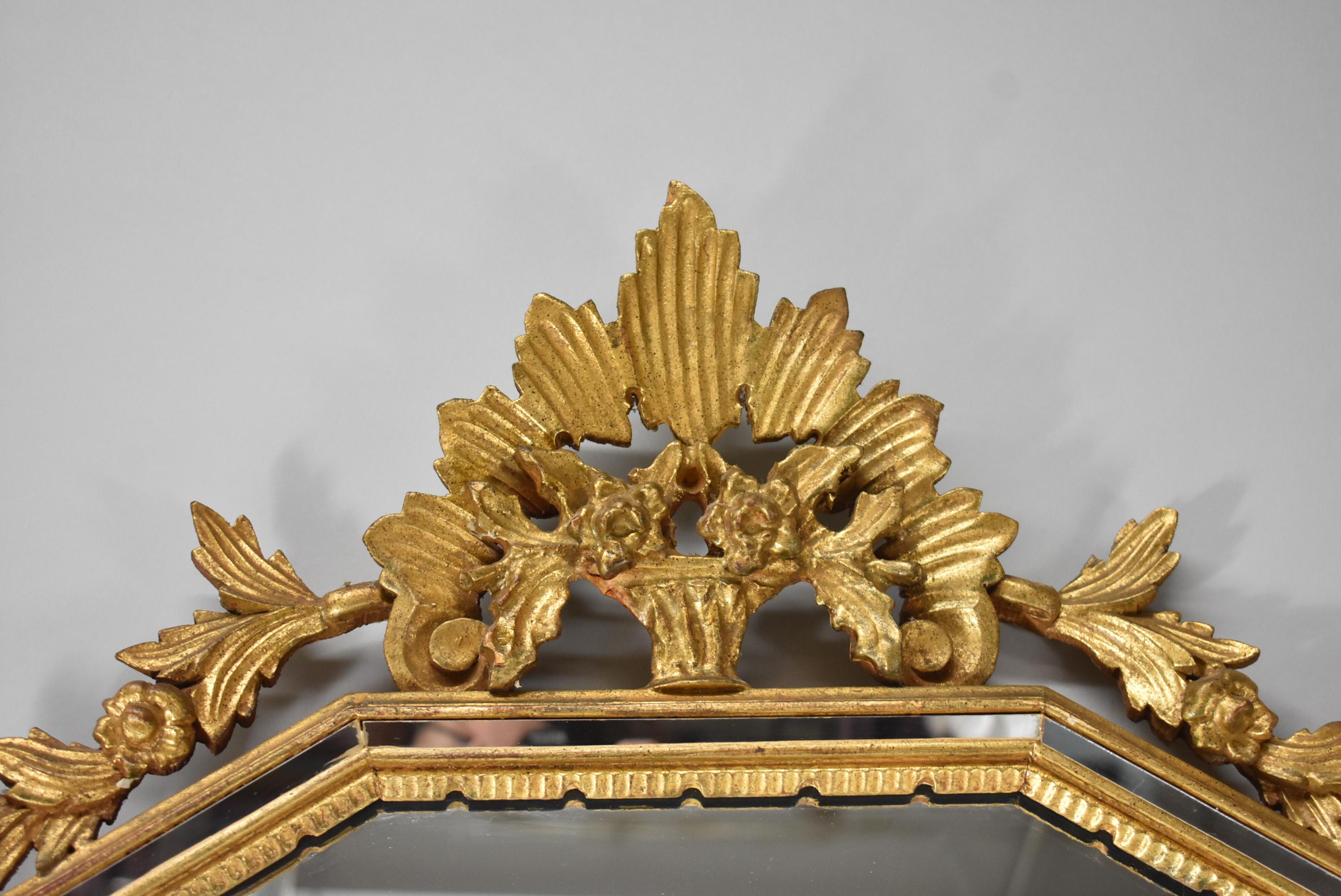 La Barge gold gilt mirror with carved floral basket details at the top. Decorative inlay mirror border.